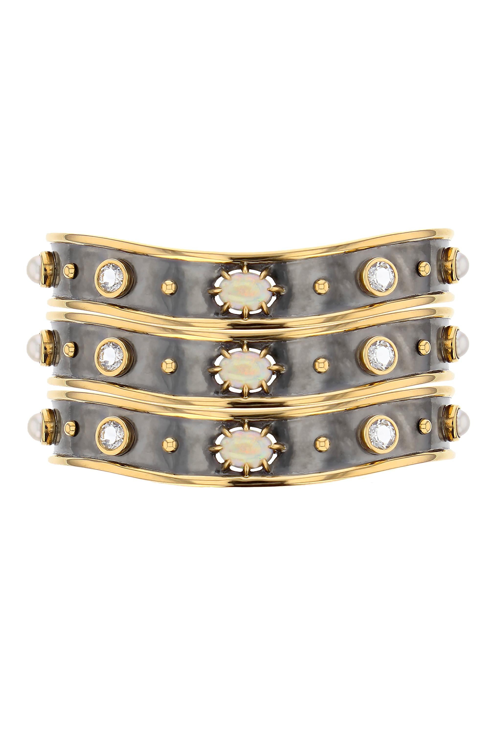 Yellow gold and distressed silver bracelet, studded with an opal, akoya pearls and white sapphires.

Details:
Opal, White  Sapphire and Akoya Pearls
White Sapphire: 1.2 cts
18k Yellow Gold: 17 g 
Distressed Silver: 11 g
Made in France