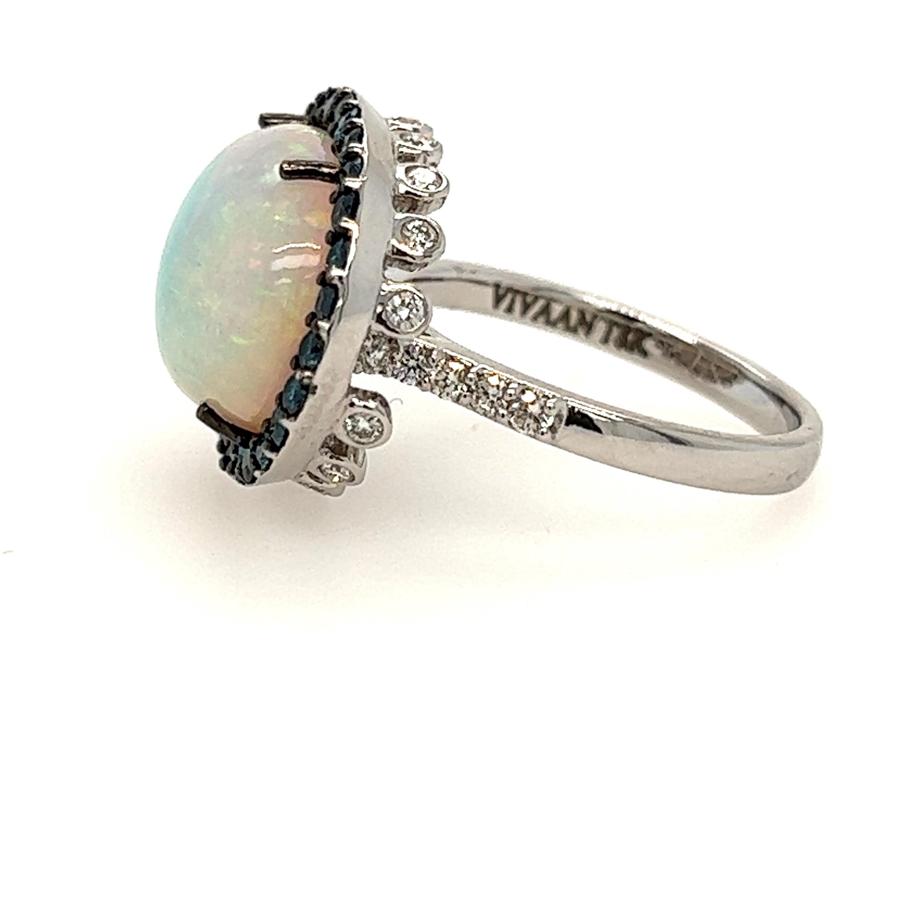 Opal and diamond ring. There are .94ct of diamonds, and the Opal weighs 5.08cts. The play of color is lovely and the mounting is 18k white gold.