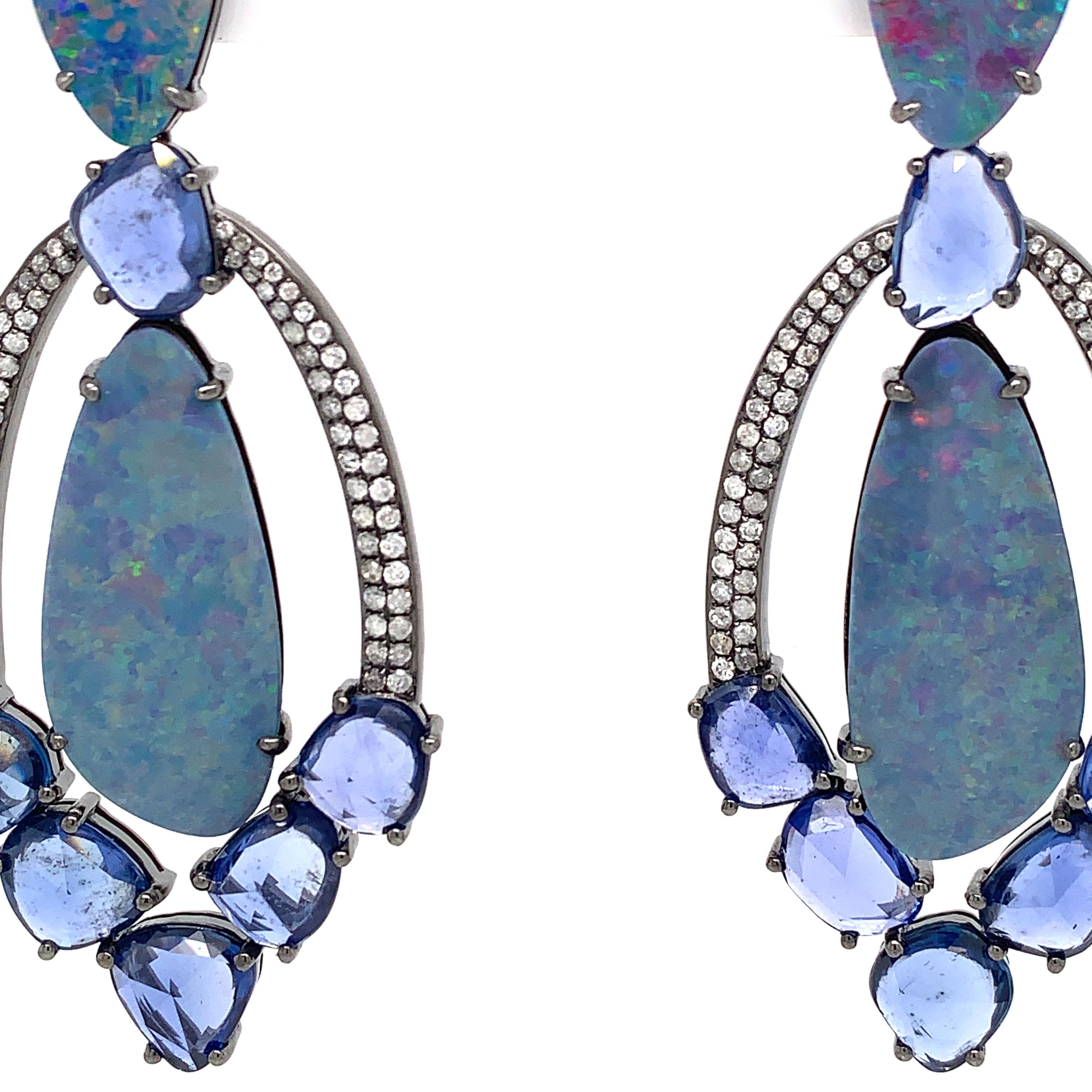Ocean Bliss Collection

Boulder Opal, blue Sapphire slice and Diamond pavé chandelier earrings set in 18K black rhodium gold.

Opal: 16.70ct total weight.
Blue Sapphire: 12.6ct total weight.
Diamonds: 0.85ct total weight.
All diamonds are G-H/SI