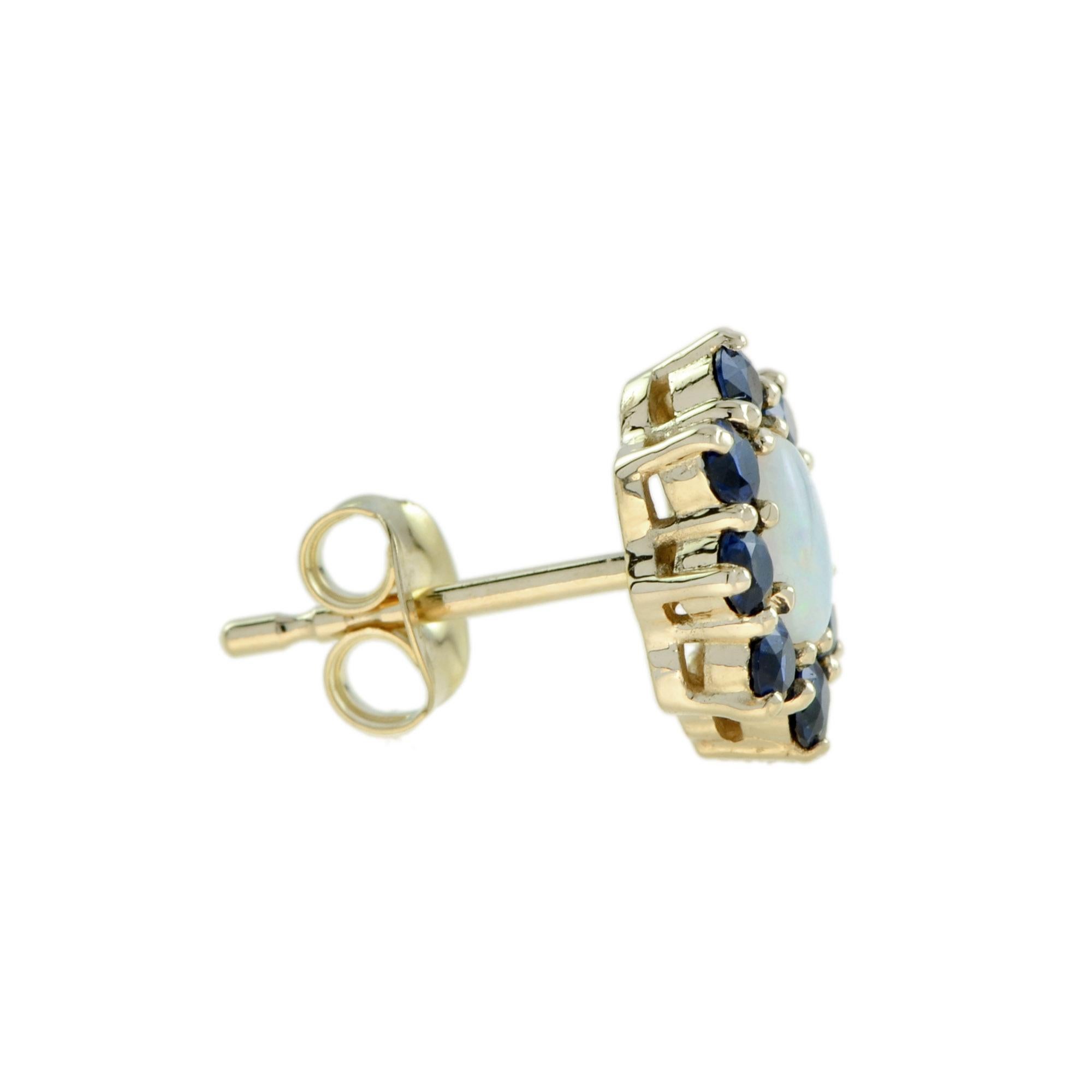 Mit acht blauen Saphiren, die einen Opal in der Mitte umgeben, sind diese floralen Ohrstecker feminin und elegant. Sie sind das perfekte Paar für einen eleganten Abend in der Stadt. 14K Gelbgold. 
Ohrringe Informationen
Stil: Vintage By
Breite: 8