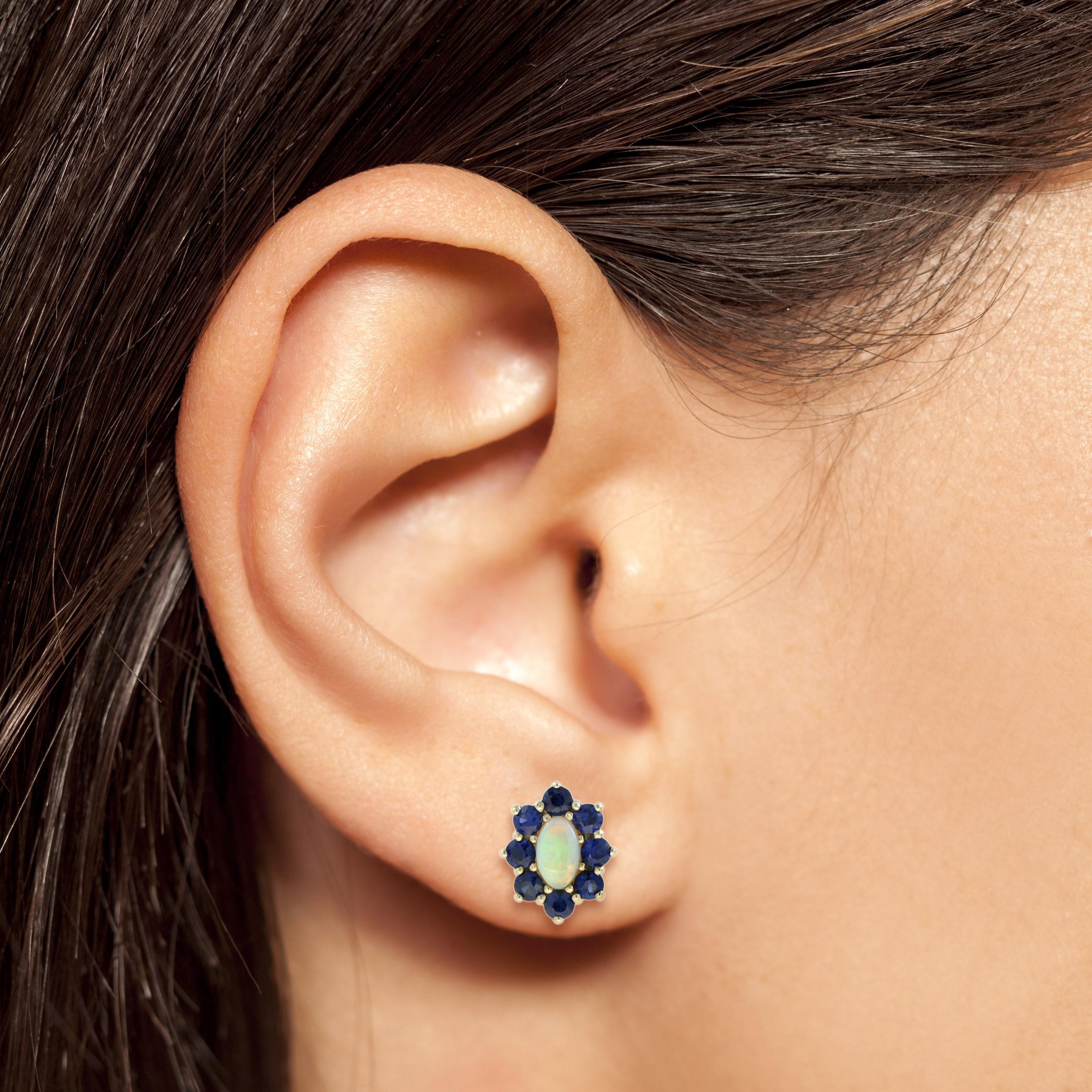 With eight blue sapphires surrounding an opal center, these floral studs are feminine and elegant. They’re the perfect pair to wear on an elegant evening out in the city

Earrings Information
Style: Vintage
Metal: 14K Yellow Gold
Width: 8