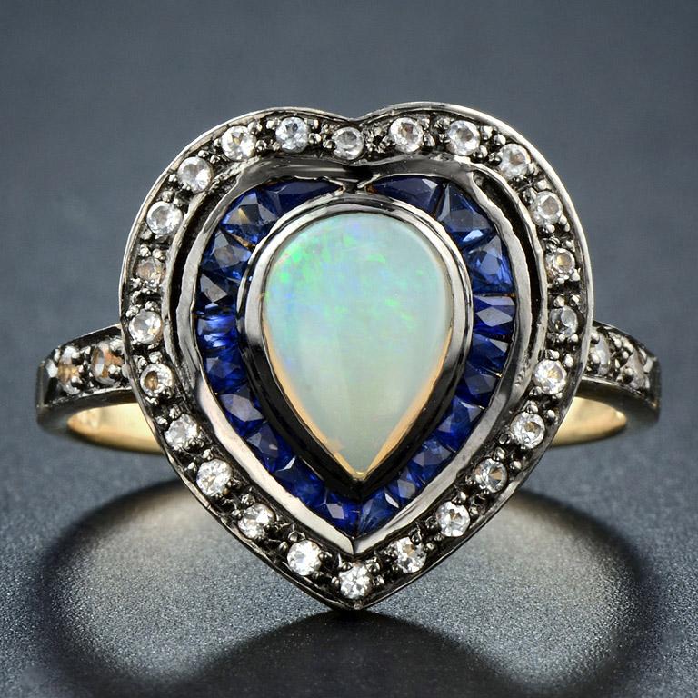 This ring was made in 9K Yellow Gold for antique style in the Victorian Era.
Center Opal (Pear 8x6 mm.) 1 piece 0.57 ct., the color of Opal is matched with fine cut Blue Sapphire (20 pcs. 0.75 ct.) and sparkle with White Topaz (25 pcs. 0.32 ct.)
And