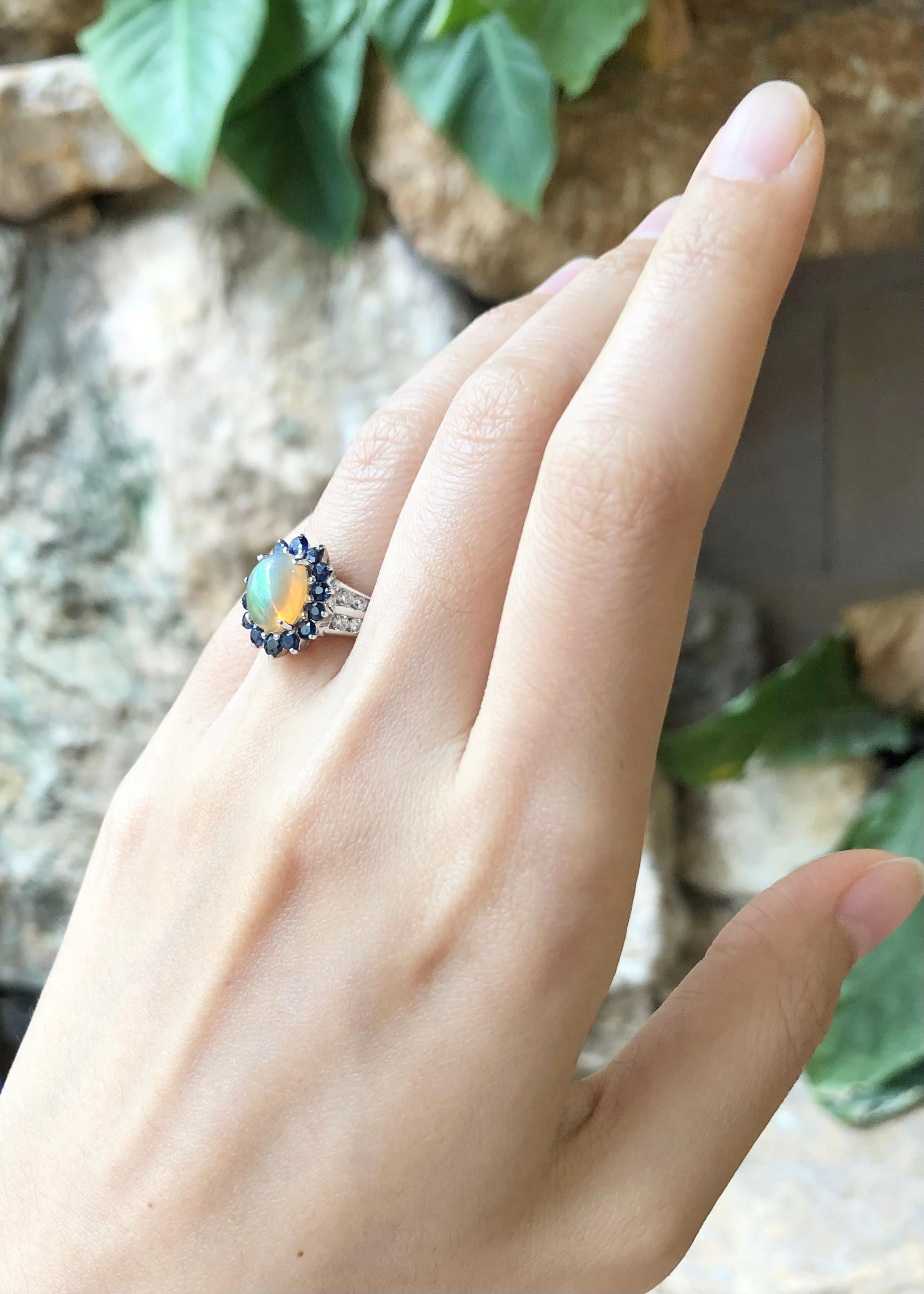 Opal, Blue Sapphire with Cubic Zirconia Ring set in Silver Settings

Width:  1.0 cm 
Length: 1.4 cm
Ring Size: 49
Total Weight: 3.82 grams

*Please note that the silver setting is plated with rhodium to promote shine and help prevent oxidation. 