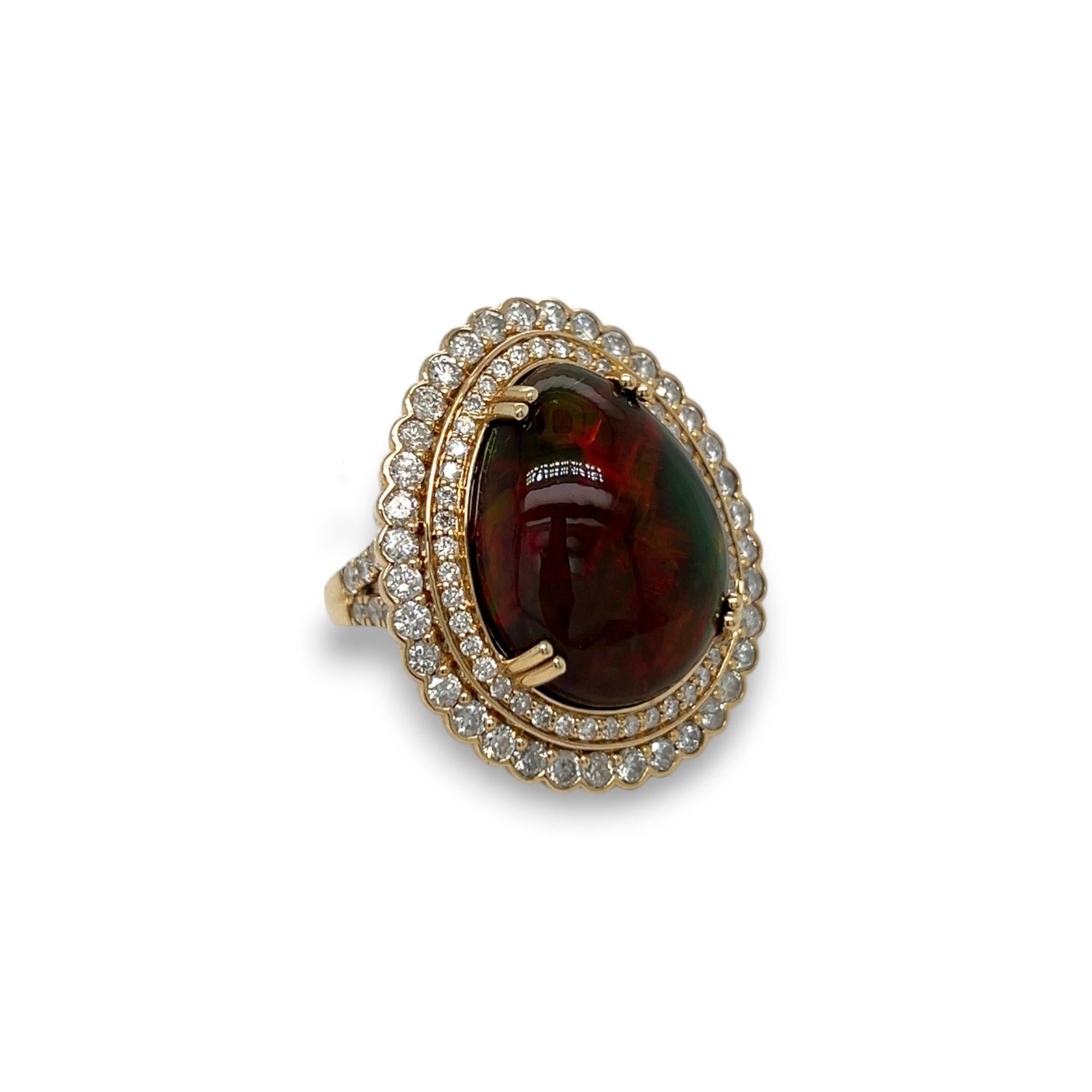 Make a statement with this beautiful opal and diamond ring. Crafted with 14k yellow gold, this ring features a stunning 11.27 carat opal cabochon as the main stone, surrounded by 2.22 total carat of sparkling diamonds. Ring can be sized upon