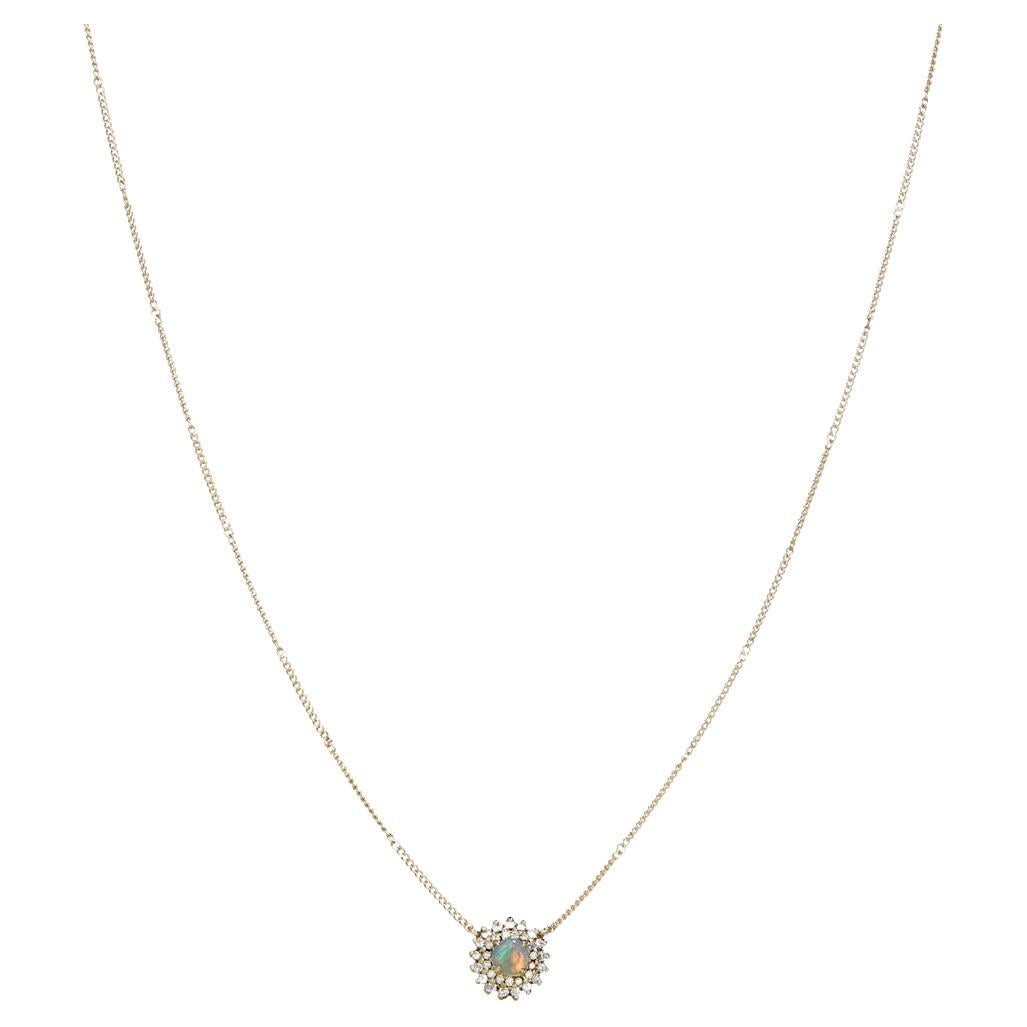 DETAILS
COLOR: Yellow gold
COMPOSITION: 14kt yellow gold
Center Australian opal totalling 0.19ct
Diamonds totalling 0.085ct  

SIZE AND FIT
Pendant 9 x 9mm 
Chain length 42cm