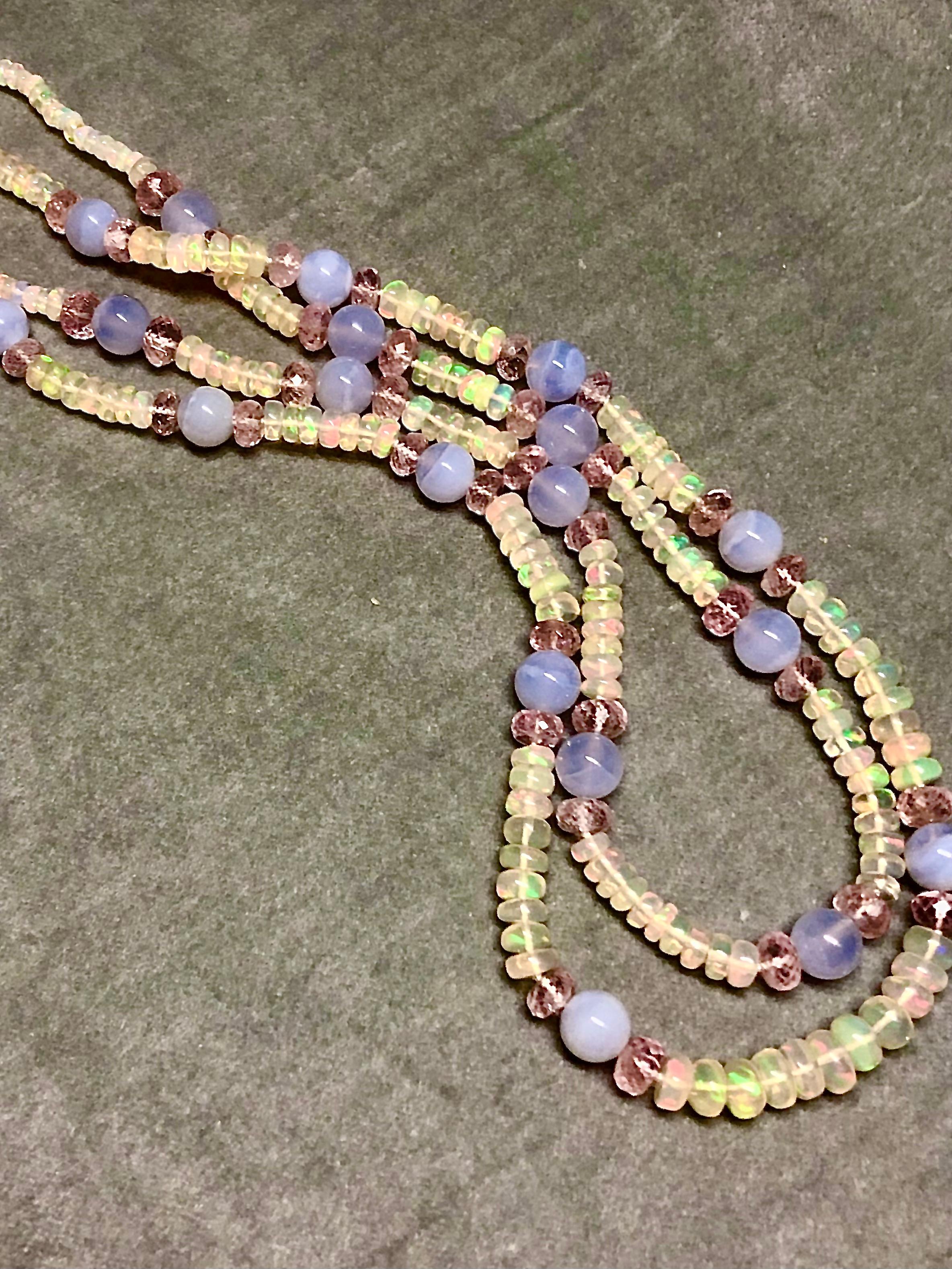 Fine chalcedony blue/grey beads flanked by raspberry tinted morganite rondelles floating like planets between mesmerizingly iridescent Ethiopian opal rondelles in this double strand necklace finished with a 14kt white gold ball clasp. This piece is