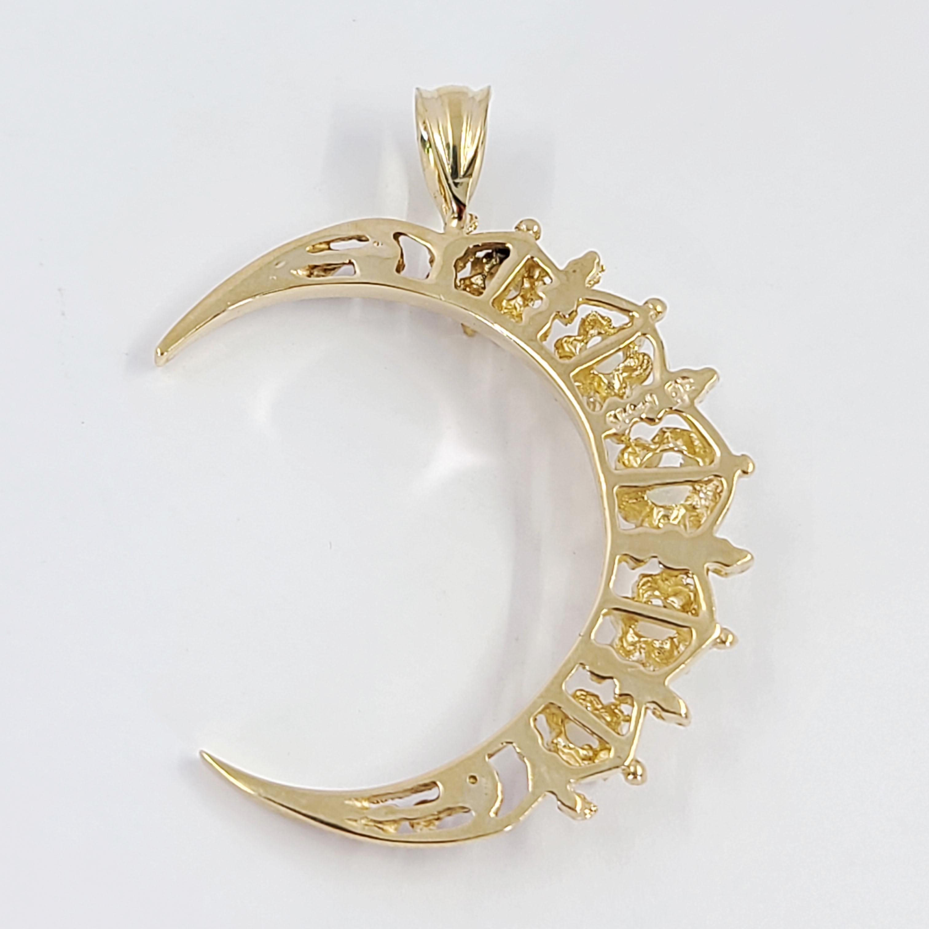 14 Karat Yellow Gold Crescent Moon Pendant Featuring 5 Round Opals Totaling Approximately 0.25 Carats. 4.5 Inches Long Including Bale. Finished Weight Is 4.2 Grams.