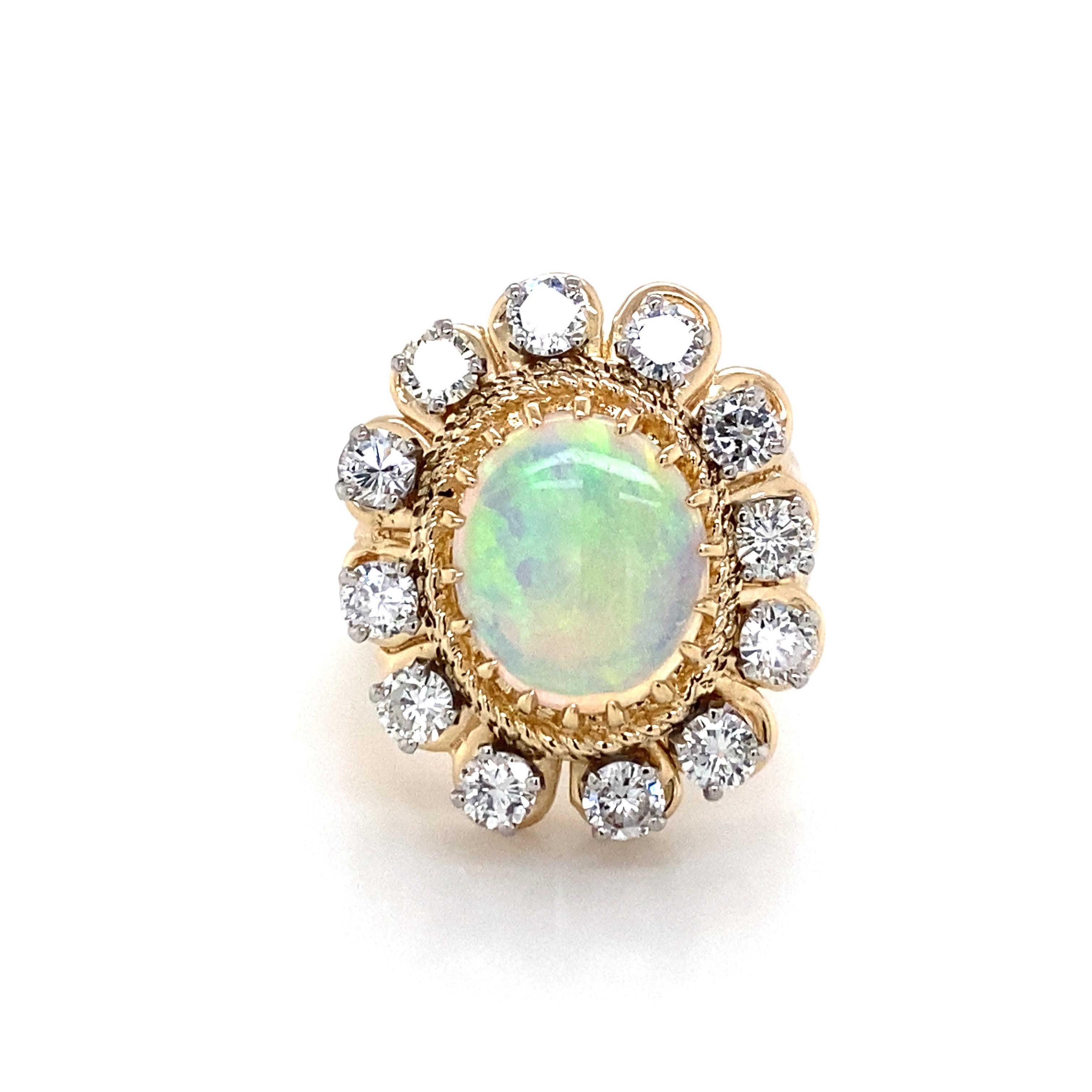 Opal Diamond 18K Two-Tone Gold Ring. (1) Opal weighing 2.60 carats and (12) Round Brilliant Cut Diamonds weighing 2.04 carat total weight, G-H in color and VS-I1 in clarity are expertly set.  The Ring measures 1 inch in length and 3/4 in width. 