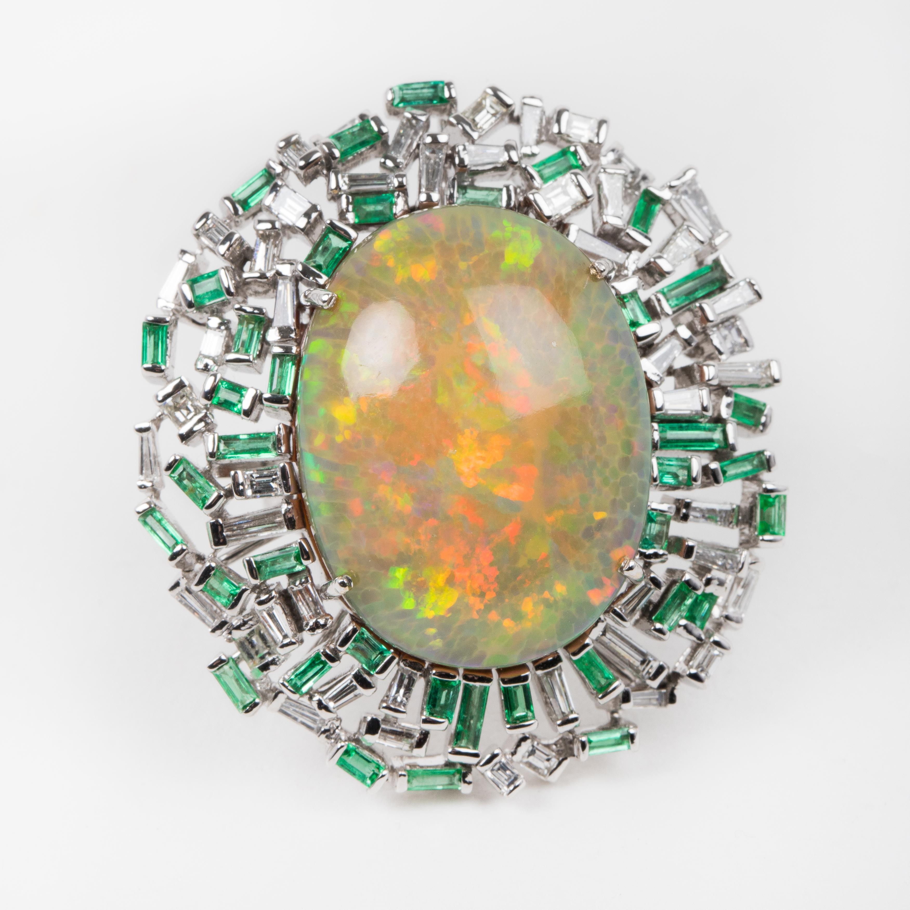 This unique ring features an amazing rainbow color opal stone set with baguette-cut emeralds and diamonds. This ring is a statement piece with gorgeous coloring. It's hard to capture the true color and luster of the opal.

Opal origin -