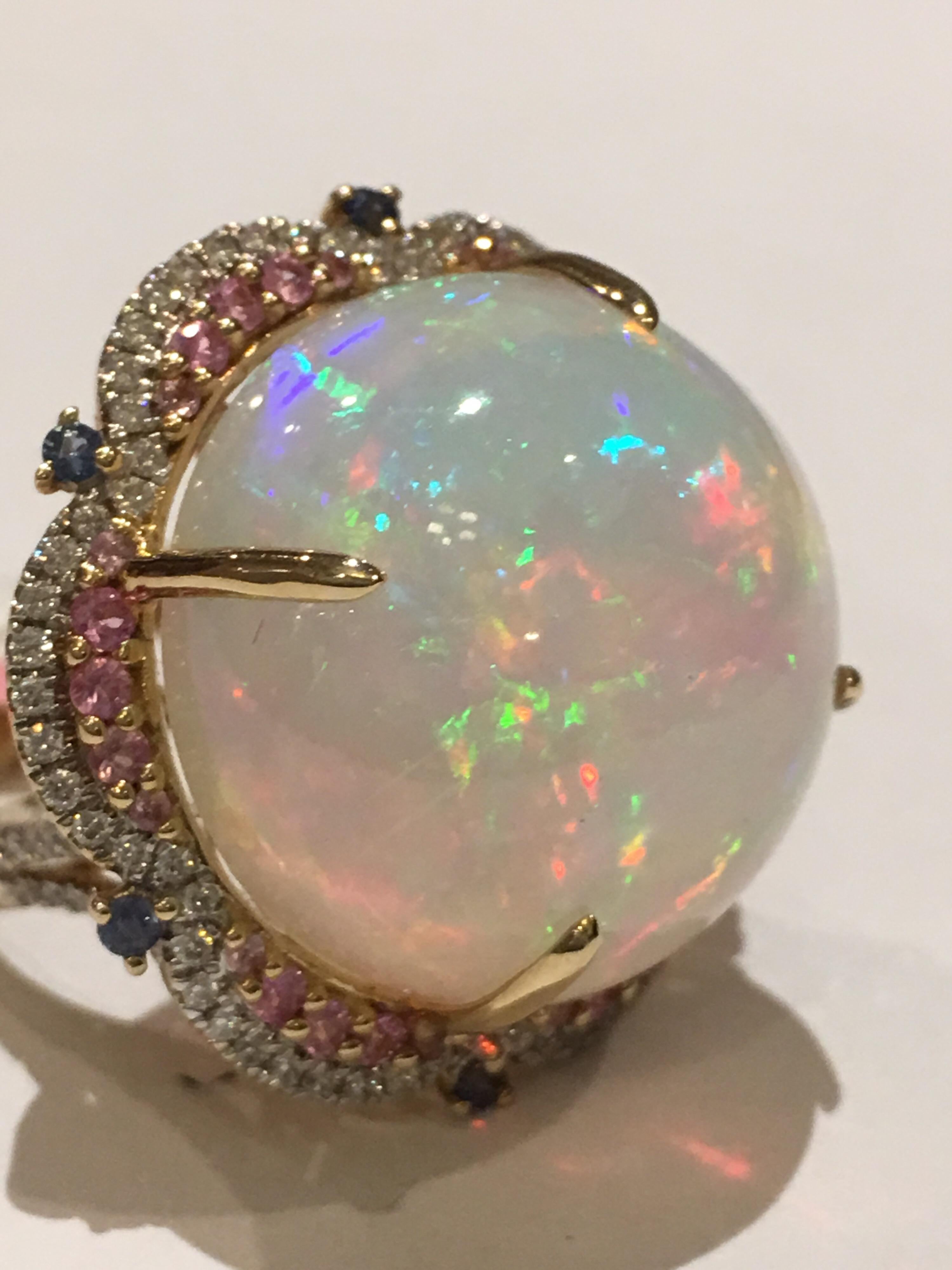 Opal Diamond and pink/Blue Sapphire  set in 14K white Gold is one of a kind Ring.
The round Opal is 29.20 Carat and 0.47 Carat white Diamonds, Both Blue and white sapphire weigh 0.60 Carat.
The size of the Ring is 7 and the ring can be resized .