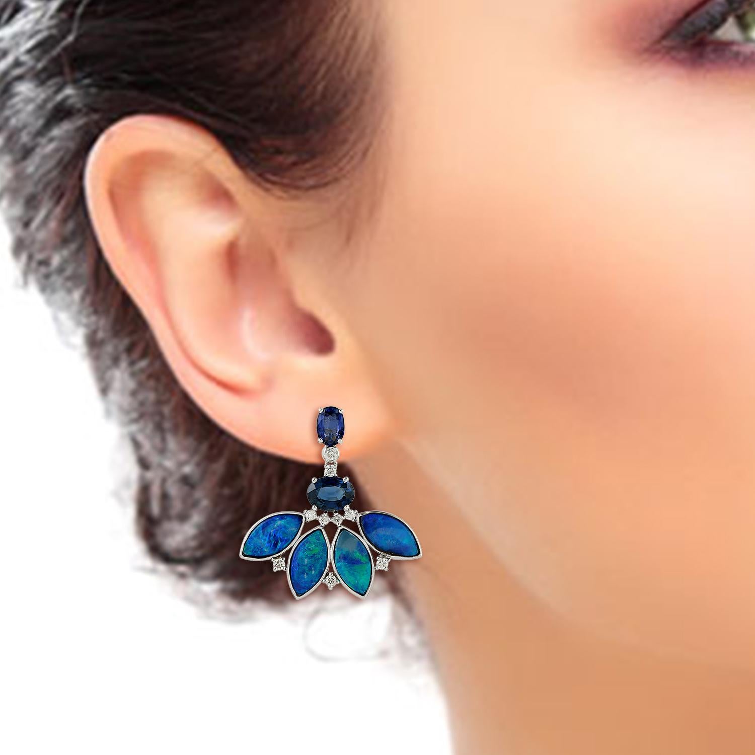 These opal diamond stud earrings are handmade in 18-karat gold. It is set in 5.53 carats opal, 3.49 carats blue sapphire and .36 carats of glittering diamonds. 

FOLLOW  MEGHNA JEWELS storefront to view the latest collection & exclusive pieces. 