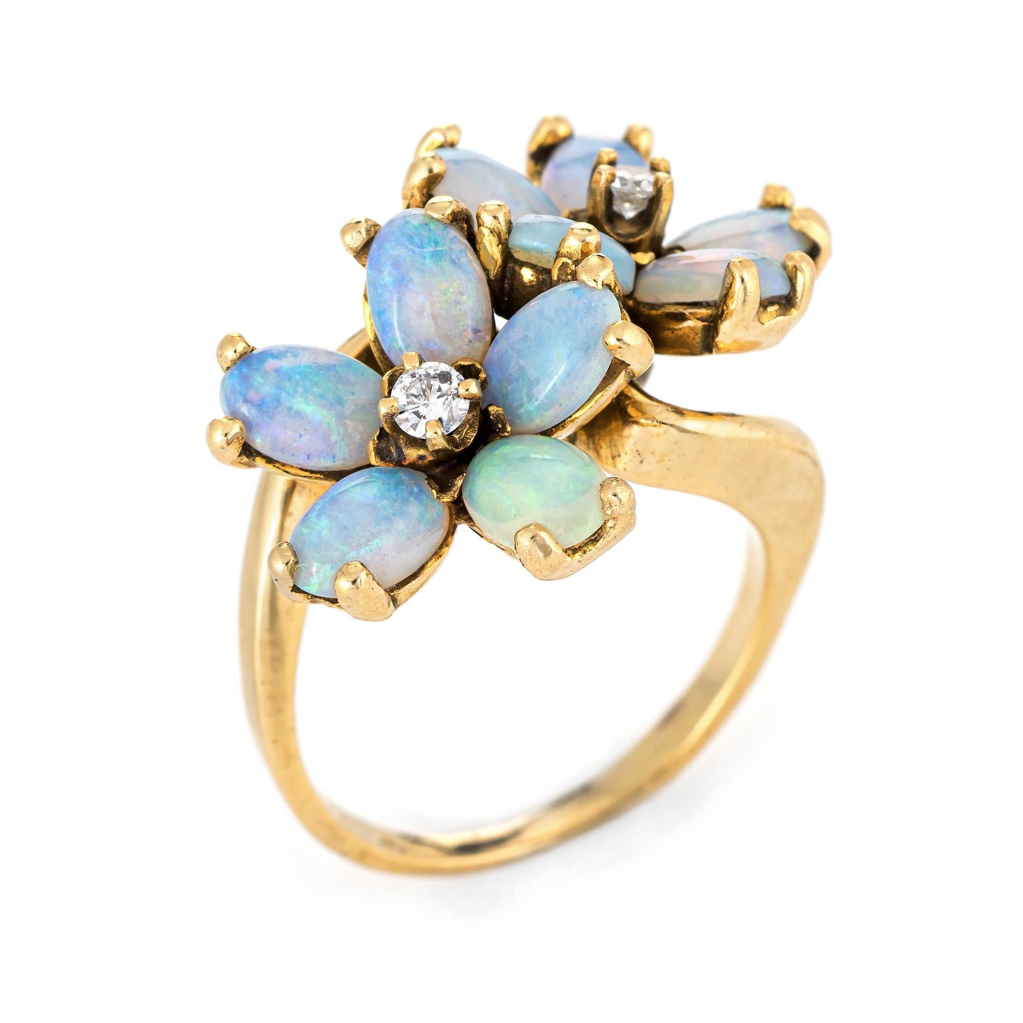 Finely detailed vintage opal & diamond double flower ring crafted in 14k yellow gold. 

10 opals each measure 5mm x 4mm (estimated at 0.35 carats each - 3.50 carats total estimated weight). Two diamonds are estimated at 0.05 carats each. The total