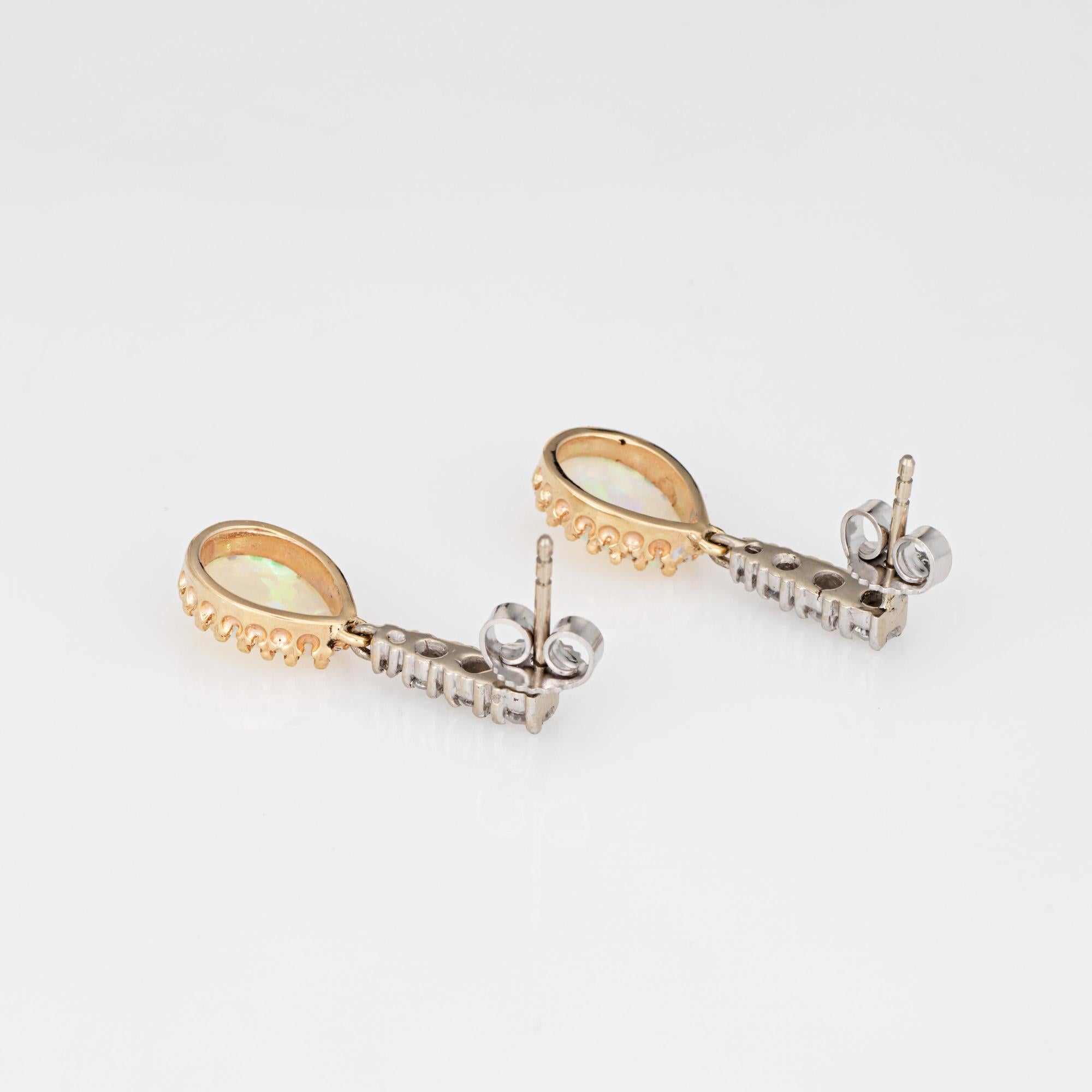 Stylish opal & diamond drop earrings crafted in 14k yellow & white gold.

Cabochon pear cut opals measure 9mm x 6mm. Diamonds total an estimated 0.10 carats (estimated at H-I color and SI1-I1 clarity). The opals are in very good condition and free