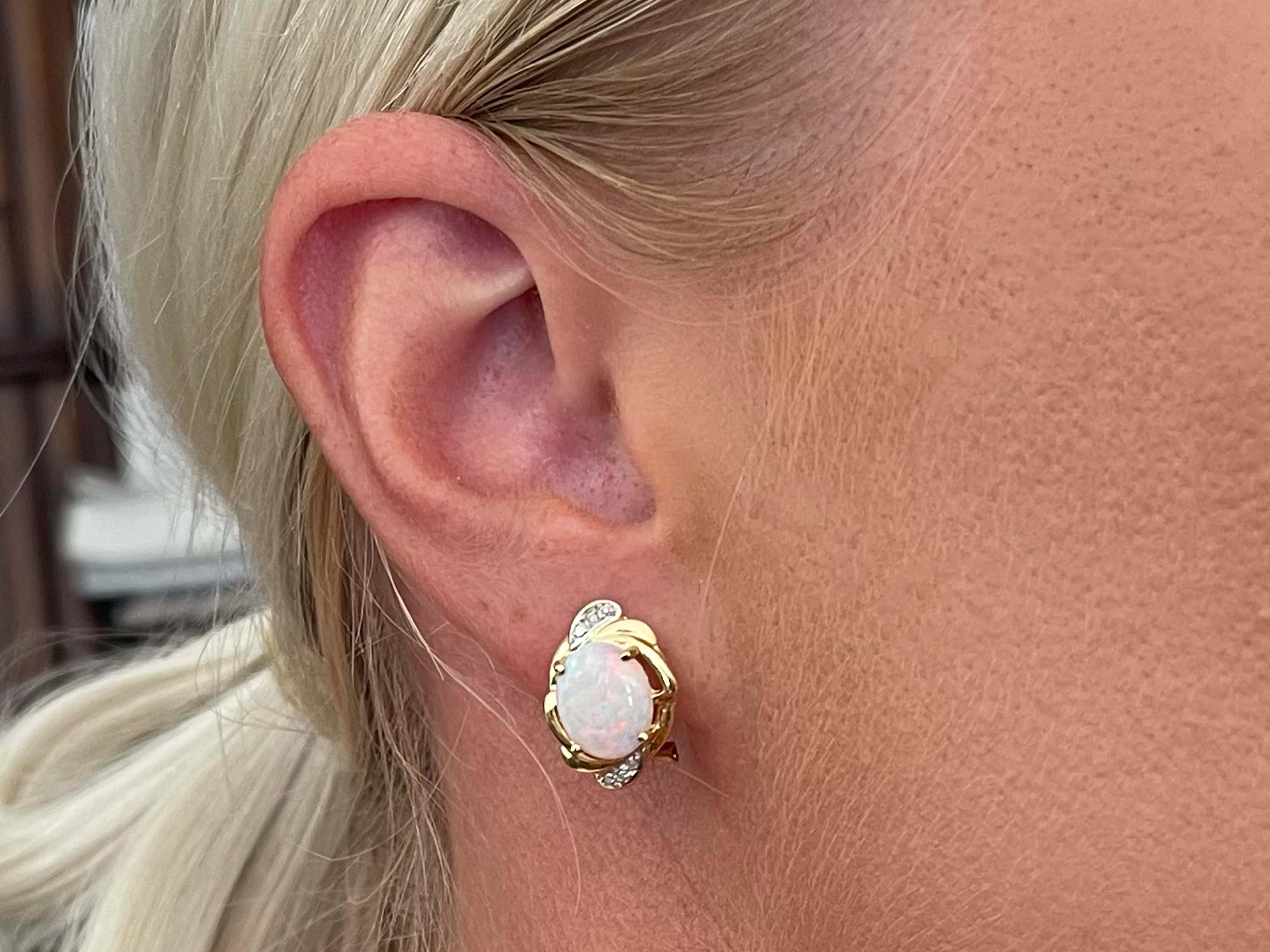 Earrings Specifications:

Metal: 14k Yellow Gold

Earring Length: 16.5 mm 

Total Weight: 4.3 Grams

Opal: 2

Opal Total Carat Weight: 1.64 carats

Diamonds: 12

Diamond Color: I

Diamond Clarity: I1

Diamond Carat Weight: 0.06 carats

Condition: