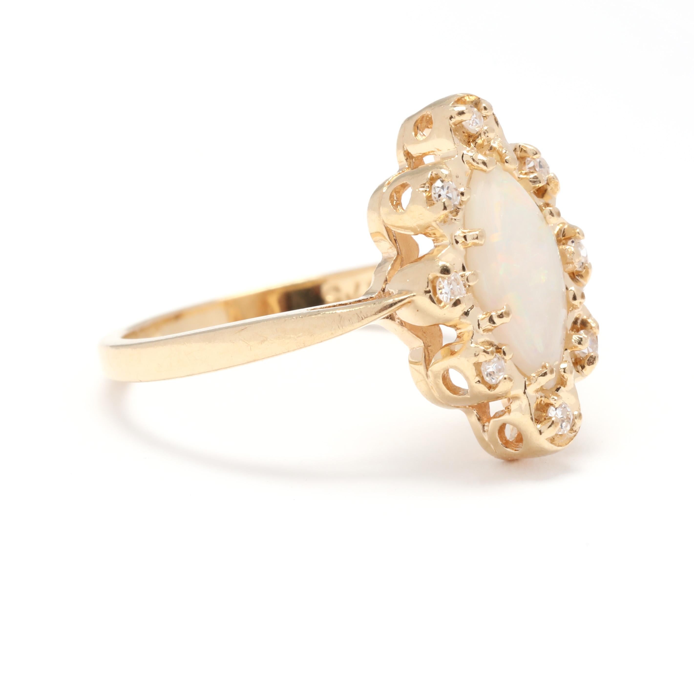 A vintage 14 karat yellow gold opal and diamond navette ring. This October birthstone ring features a prong set, cabochon marquise cut opal weighing approximately .60 carat surrounded by a scalloped halo of single cut round diamonds weighing