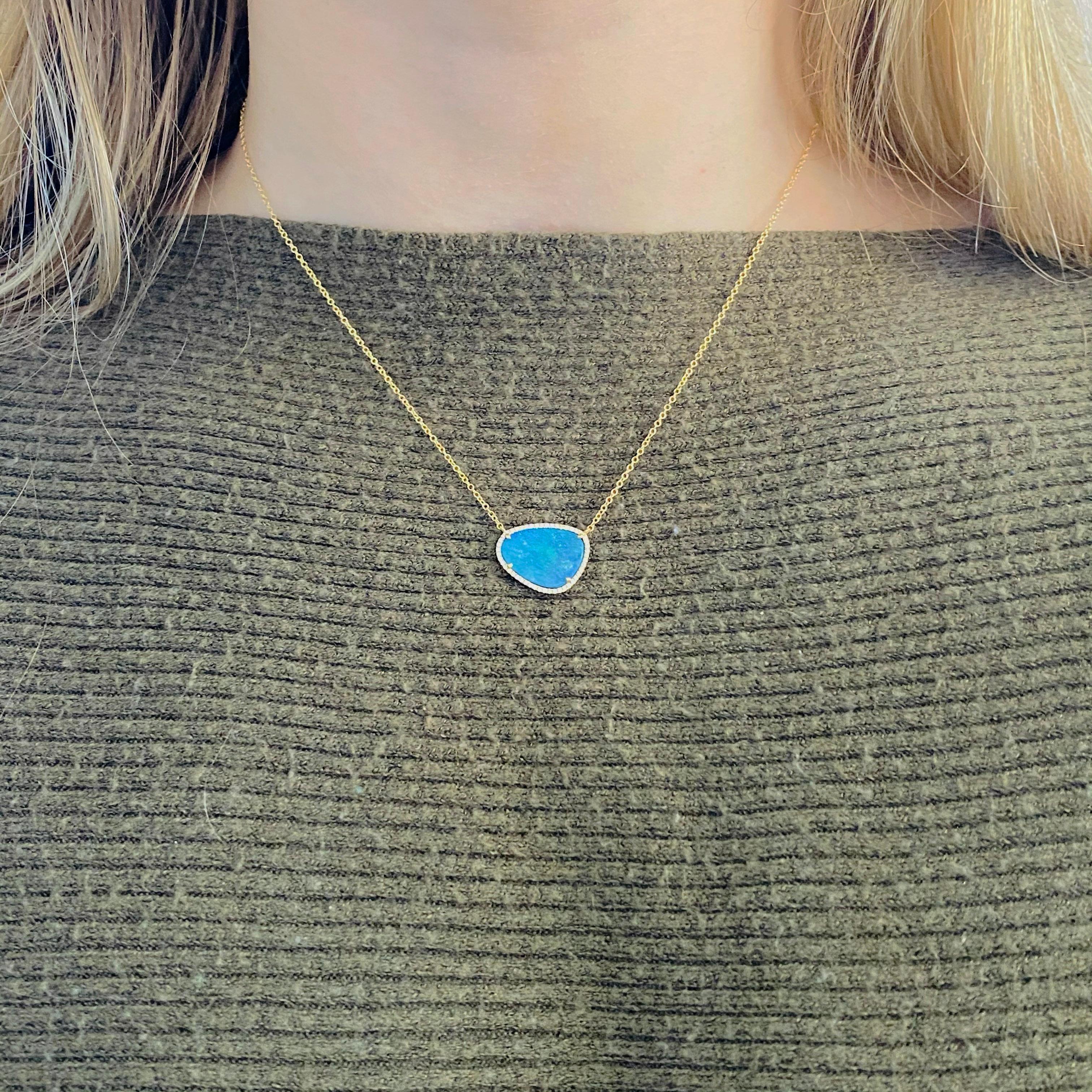 The genuine natural blue opal is stunning on anyone's neck.  The diamonds encircling the opal makes it even more intriguing.  Encircled with the 14 karat yellow gold the color of the natural opal really pops! The details for this beautiful necklace