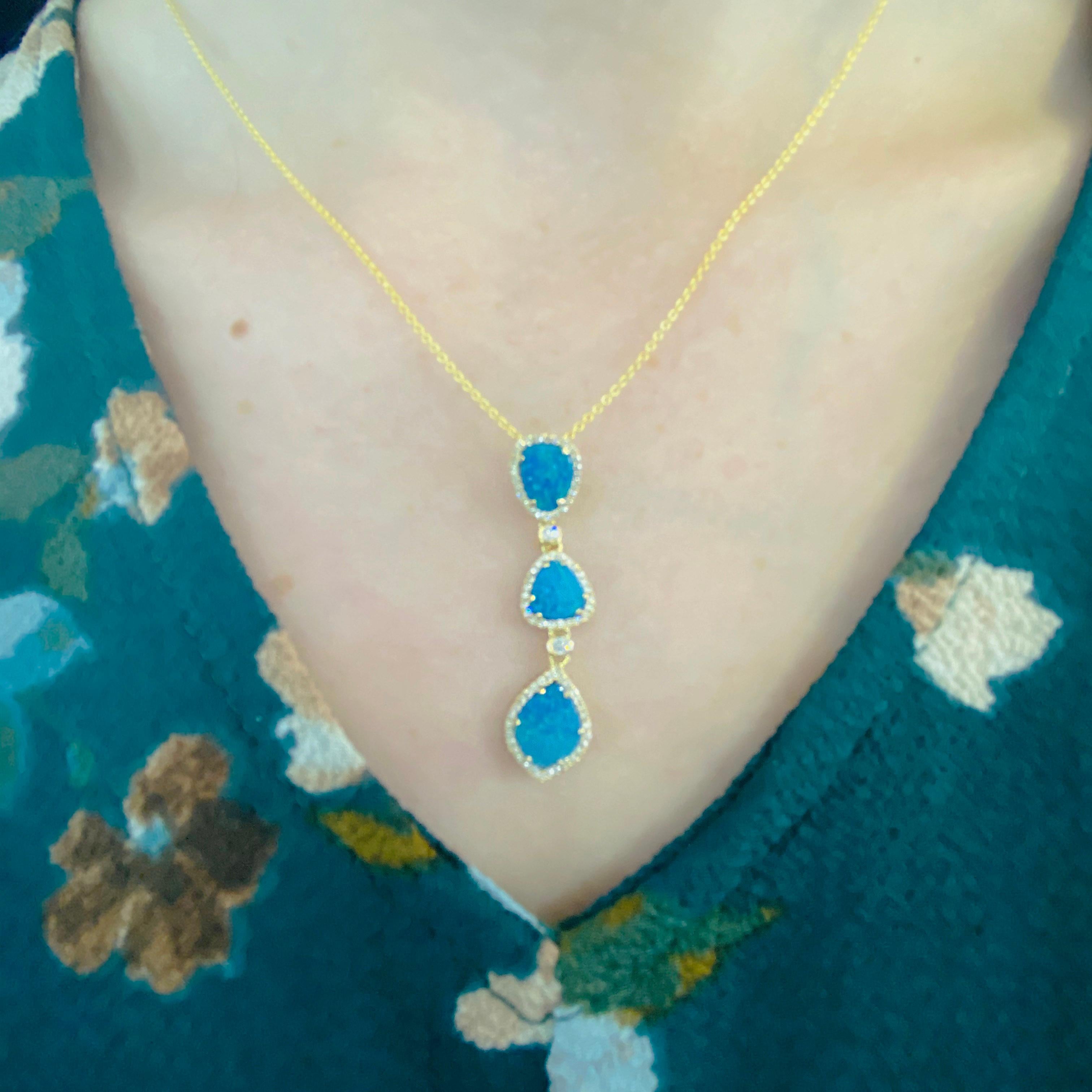 These stunningly beautiful black opal doublets set in polished 14k yellow gold and dripping with diamonds provide a look that is very modern yet classic! This necklace is very fashionable and can add a touch of style to any outfit, yet it is also