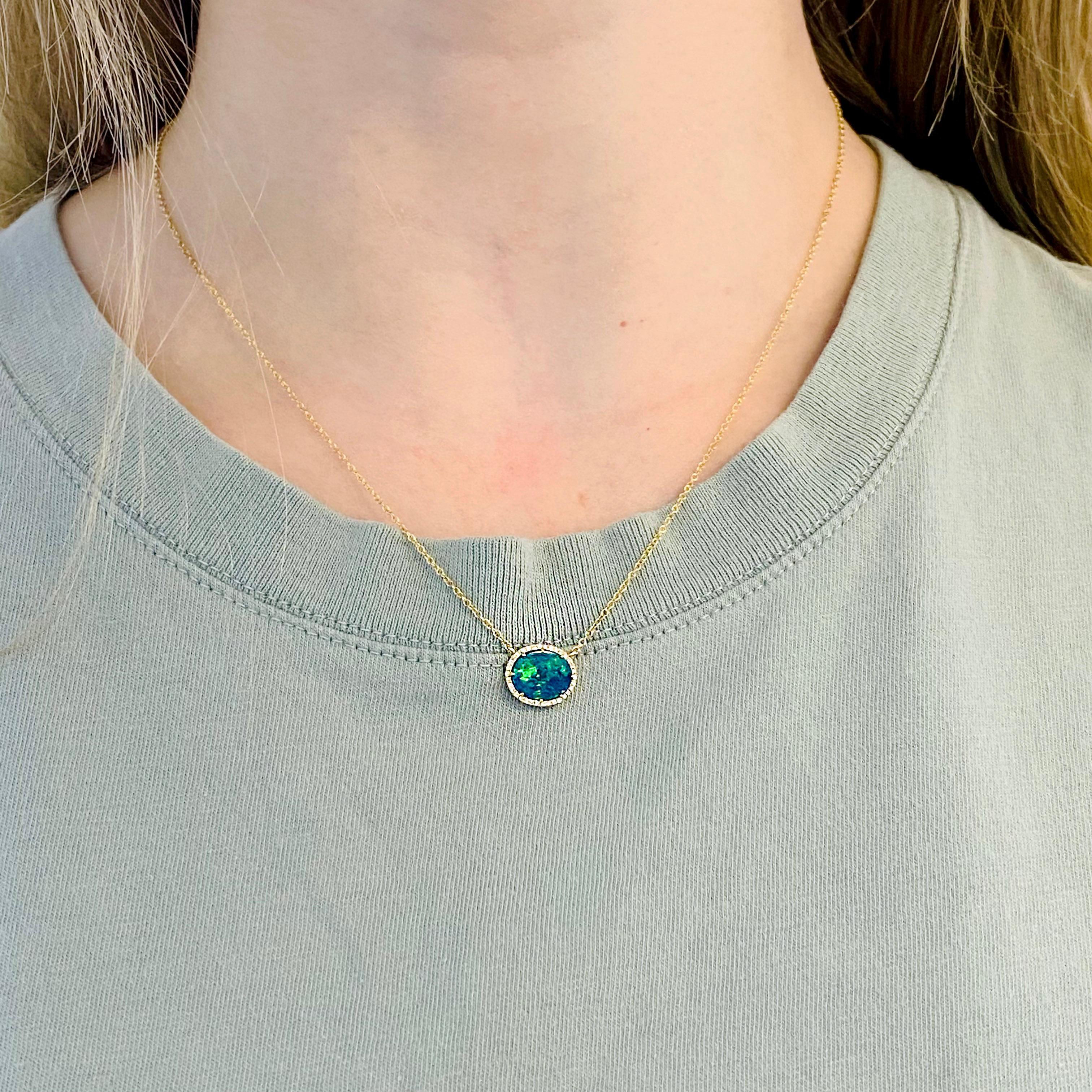 The genuine natural blue opal is stunning on anyone's neck.  The diamonds encircling the opal makes it even more intriguing.  Encircled with the 14 karat yellow gold the color of the natural opal really pops! The details for this beautiful necklace