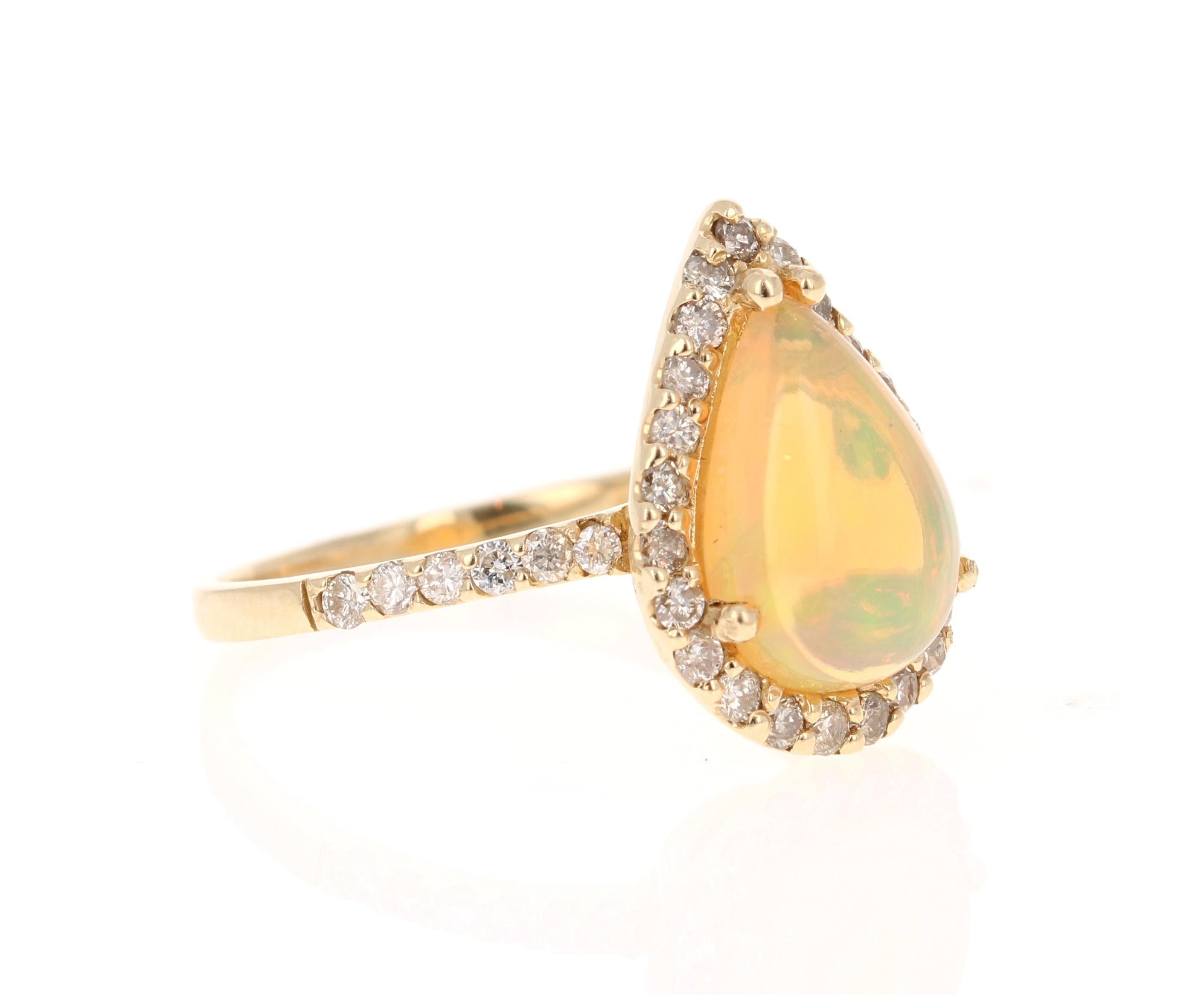 This ring has a beautiful Pear Cut semi-transparent Opal that is 1.82 carats. It is surrounded by 35 Round Cut Diamonds that weigh 0.57 carats. The total carat weight of the ring is 2.39 carats. 

The ring is made in 14K Yellow Gold and weighs