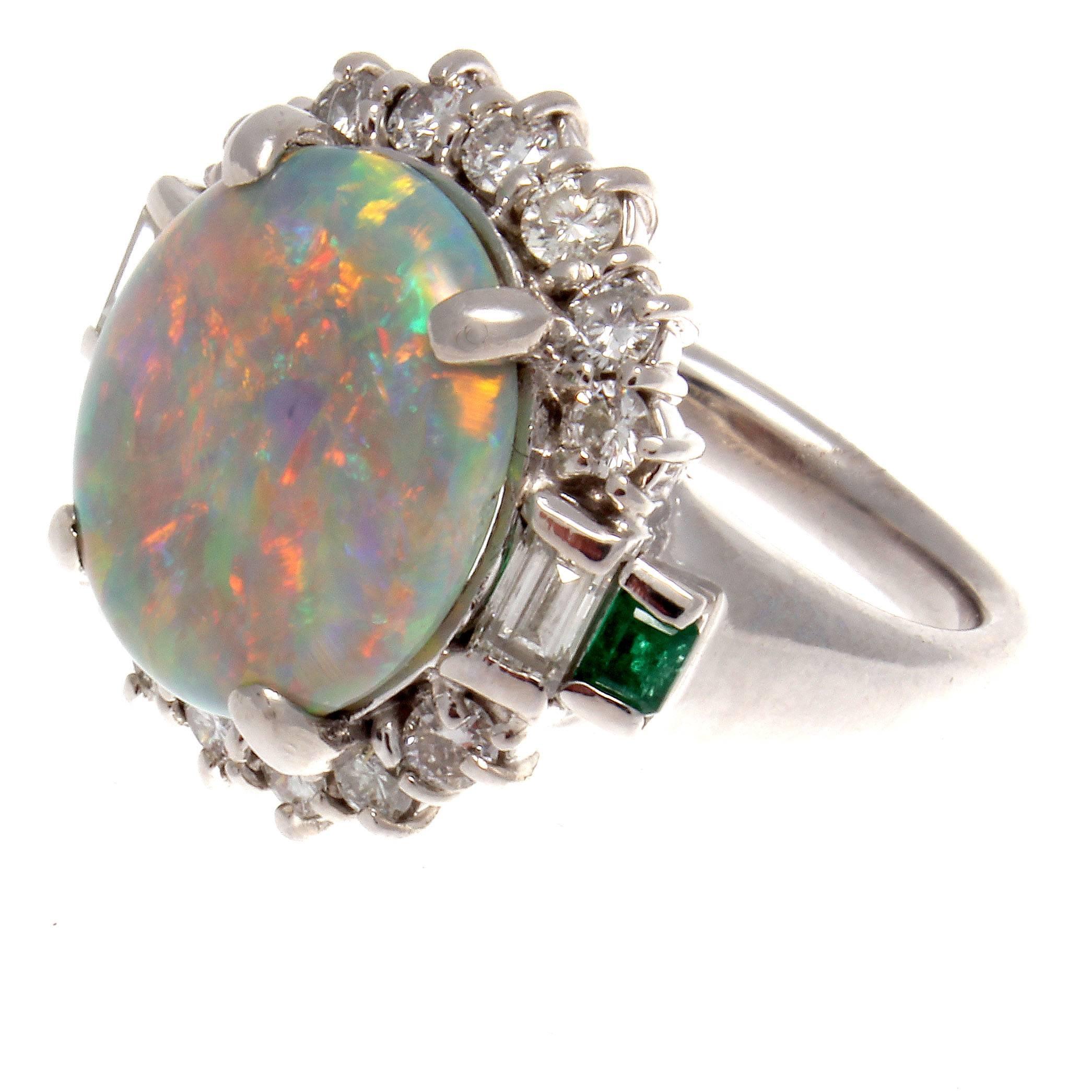 Good opals are like a painters palette.  This opal is particularly colorful and radiates the best of Impressionist art. A 4.47 carat opal that features an array of colors perfectly surrounded by colorless diamonds weighing 0.92 carats and accented