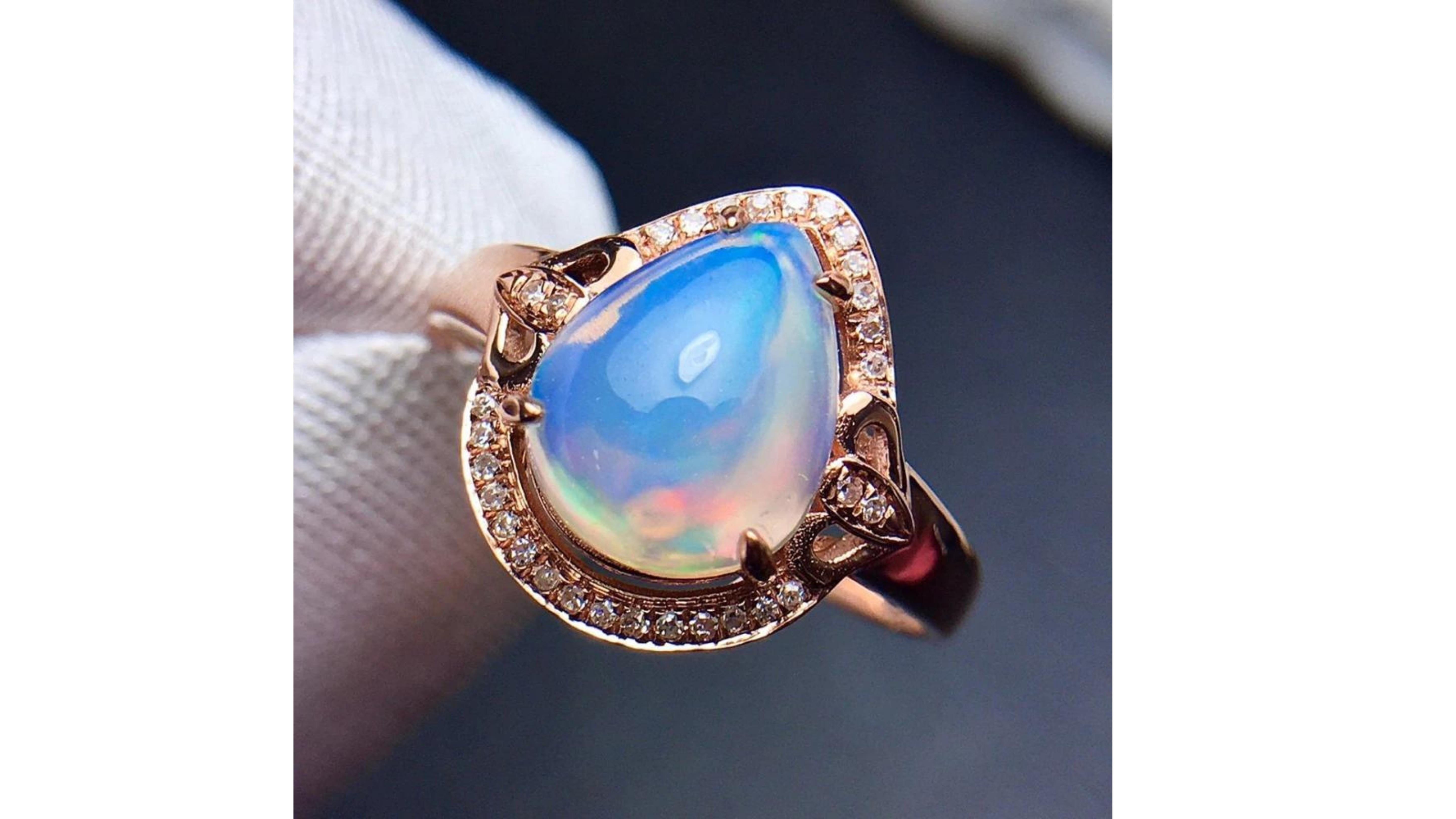 Opal Diamond Ring 18 Karat Rose Gold with 30 diamonds .  This  Ethiopian  Opal Shows off bright colors Blue Pink Yellow Green ...  And does stand out in the rose gold. 
These comes from the Wello Province in Ethiopia were they are known for bright