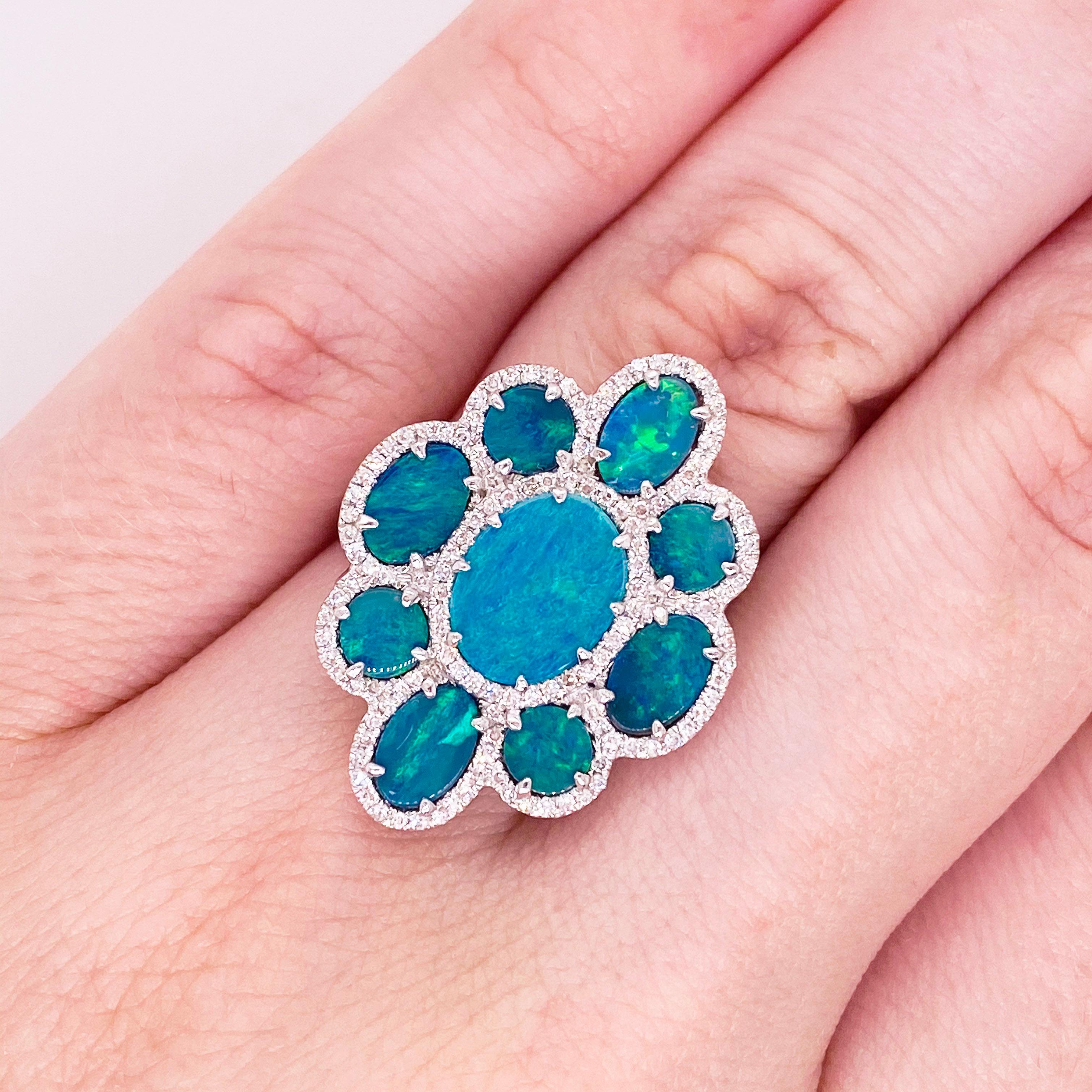 These stunning black opal doublets surrounded by polished 18k white gold and dripping with gorgeous diamonds provide a look that is very modern! This ring is very fashionable and can add a touch of style to any outfit, yet it is also classy enough