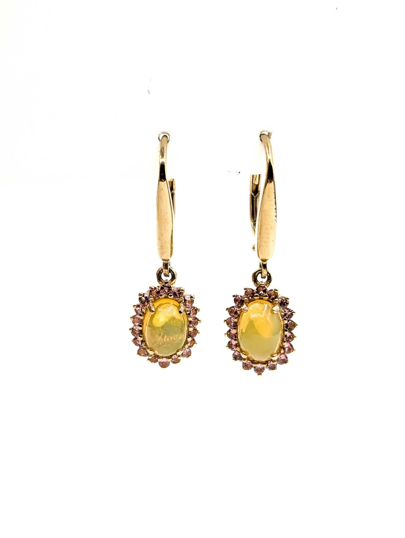 Opal & Diamond & Topaz Drop Earrings in 14k Yellow Gold

These earrings are crafted in 14k yellow gold and feature opal, with a drop design. The opal weighs 1.1ct. The pink topaz weighs 0.36ct. The round diamonds total 0.02ctw, near colorless with I