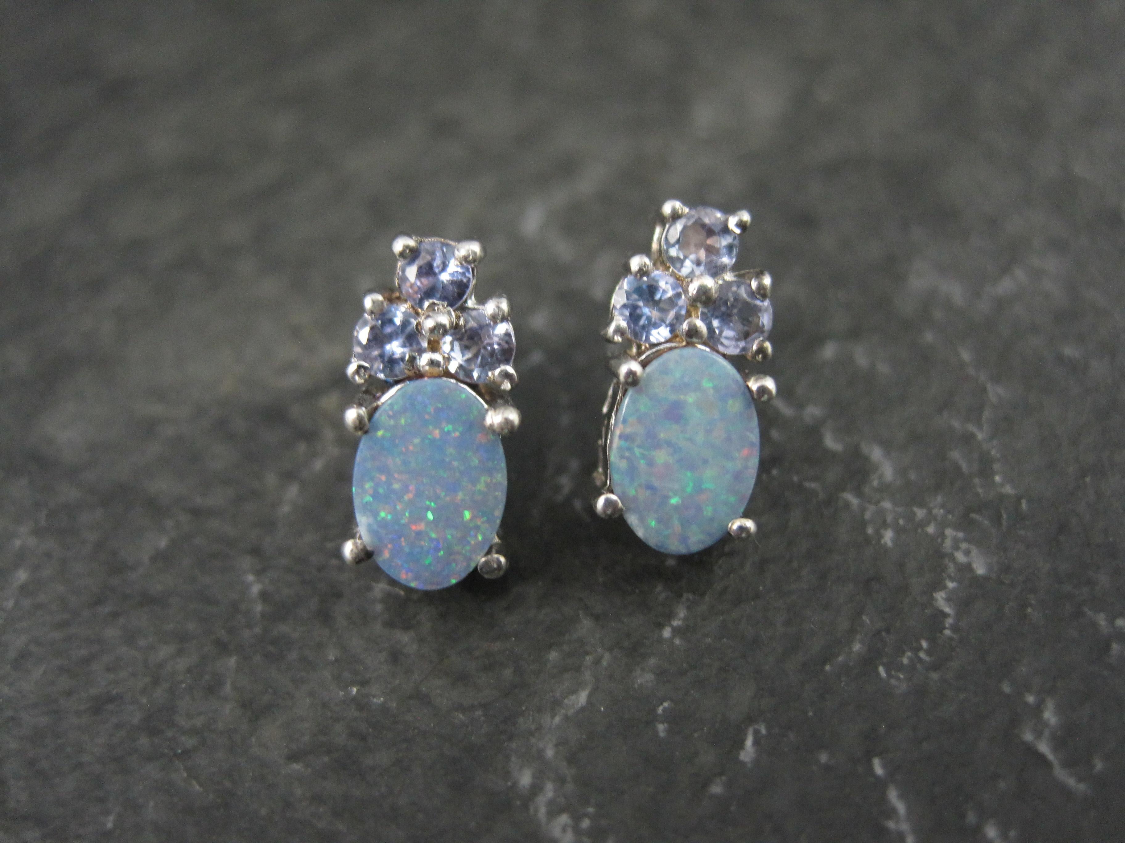 These gorgeous stud earrings are sterling silver with 5x7mm oval opal doublets and a combination of 6 round cut, 3mm tanzanites.
Measurements: 1/4 by 1/2 of an inch
Marks: 925, Chuck Clemency's STS hallmark
Condition: New old stock