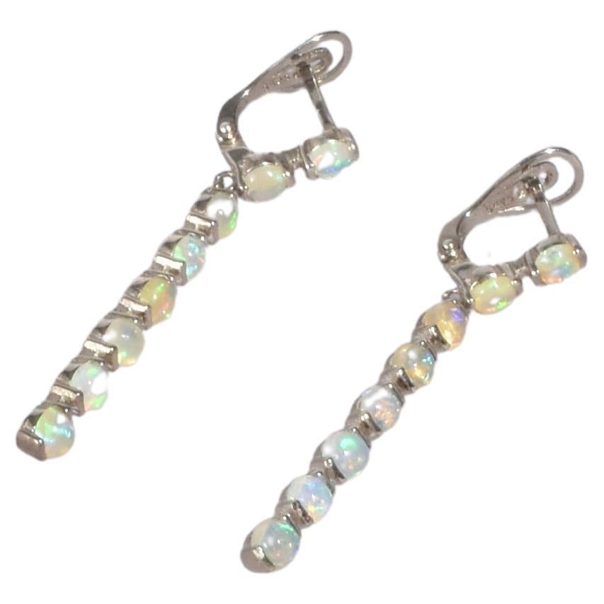 Stunning vintage silver earrings with cascading opal detail, pierced. Stamped 925.

Material: Sterling silver, opal.

We recommend storing in a dry place and periodic polishing with a cloth. 