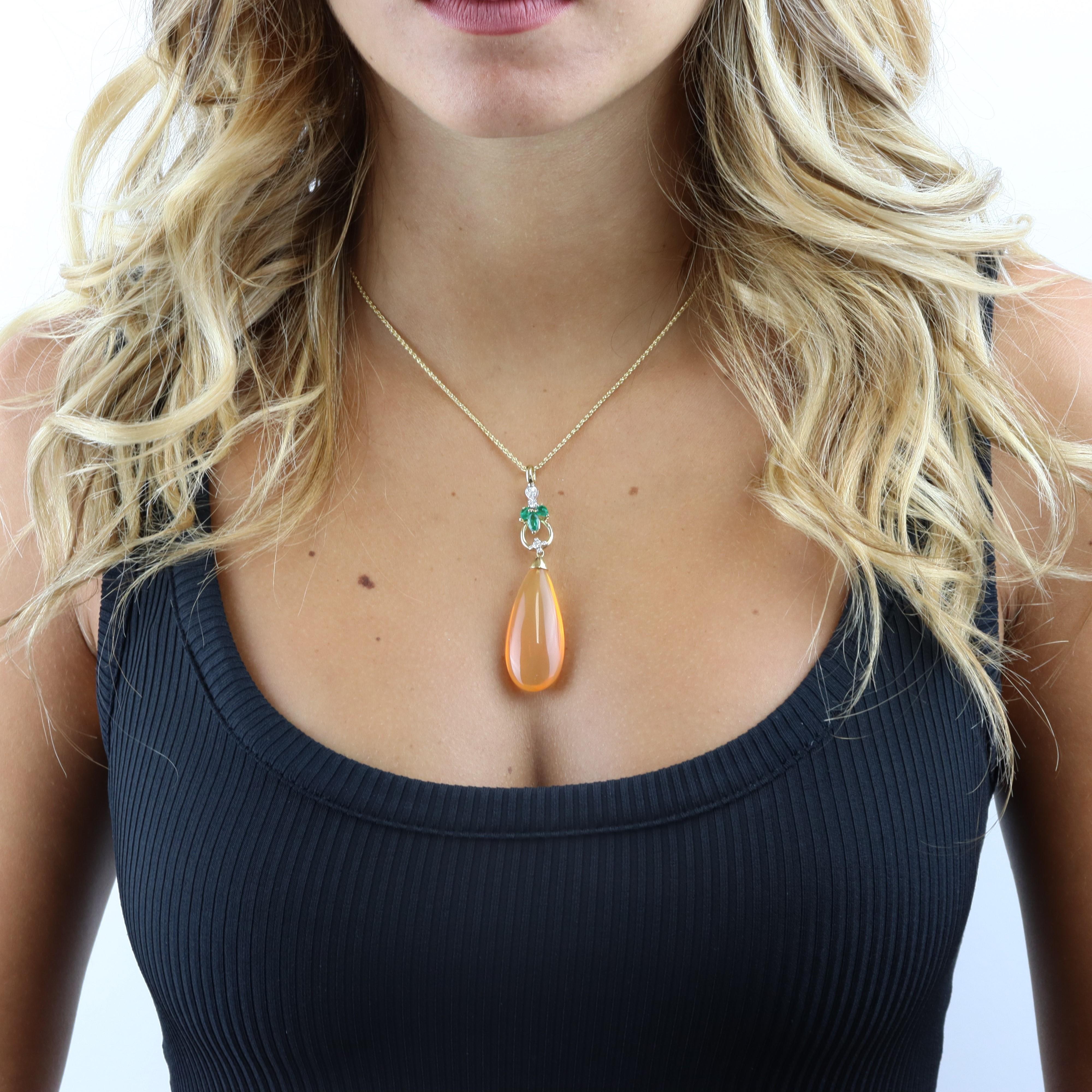 This gorgeous 18 Kt yellow and white gold pendant necklace features a drop-shaped opal. It is further embellished with emerald and diamond accents to complete the sophisticated, feminine look. The Arab peoples deem opal a gift from the heavens. The