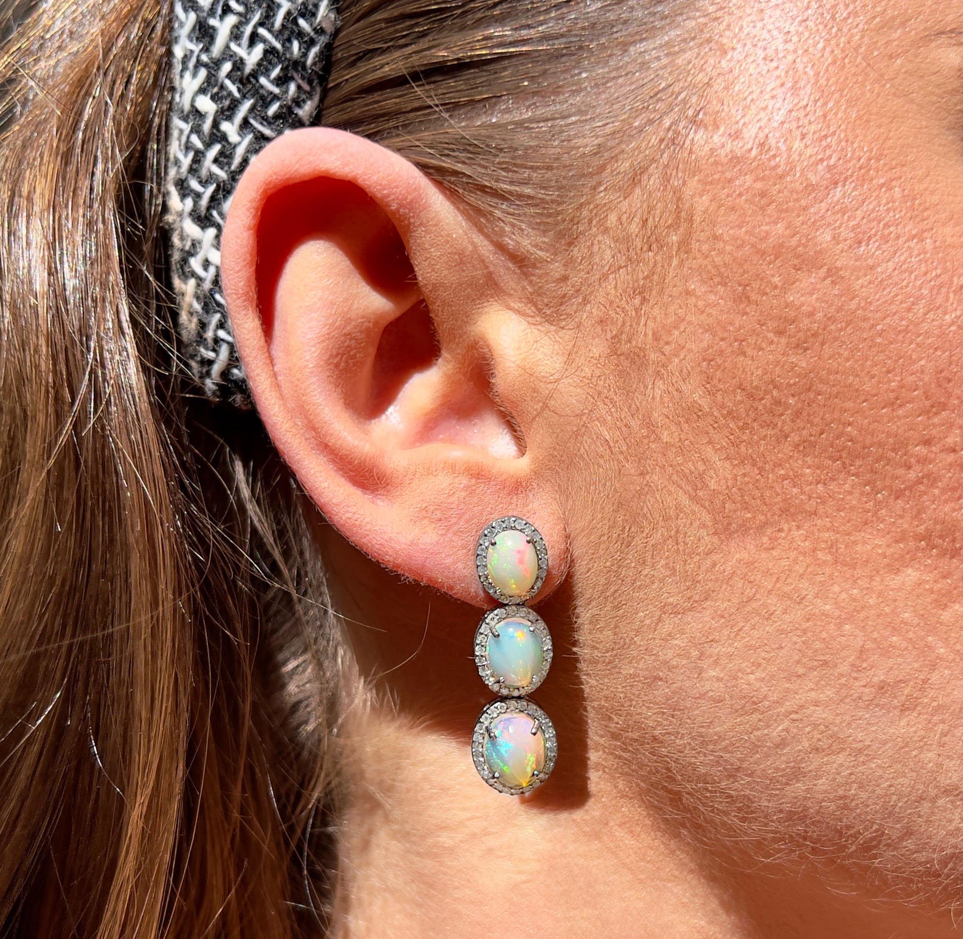 It comes with the appraisal by GIA GG/AJP
Condition: Excellent
Opals =  8 Carats
Diamonds = 1.02 Carats
(Color: F-J, Clarity: VS-I)
Metal: Silver & 14K Yellow Gold
Earrings Length: 1.42 Inches
Earrings Width: 0.42 Inches