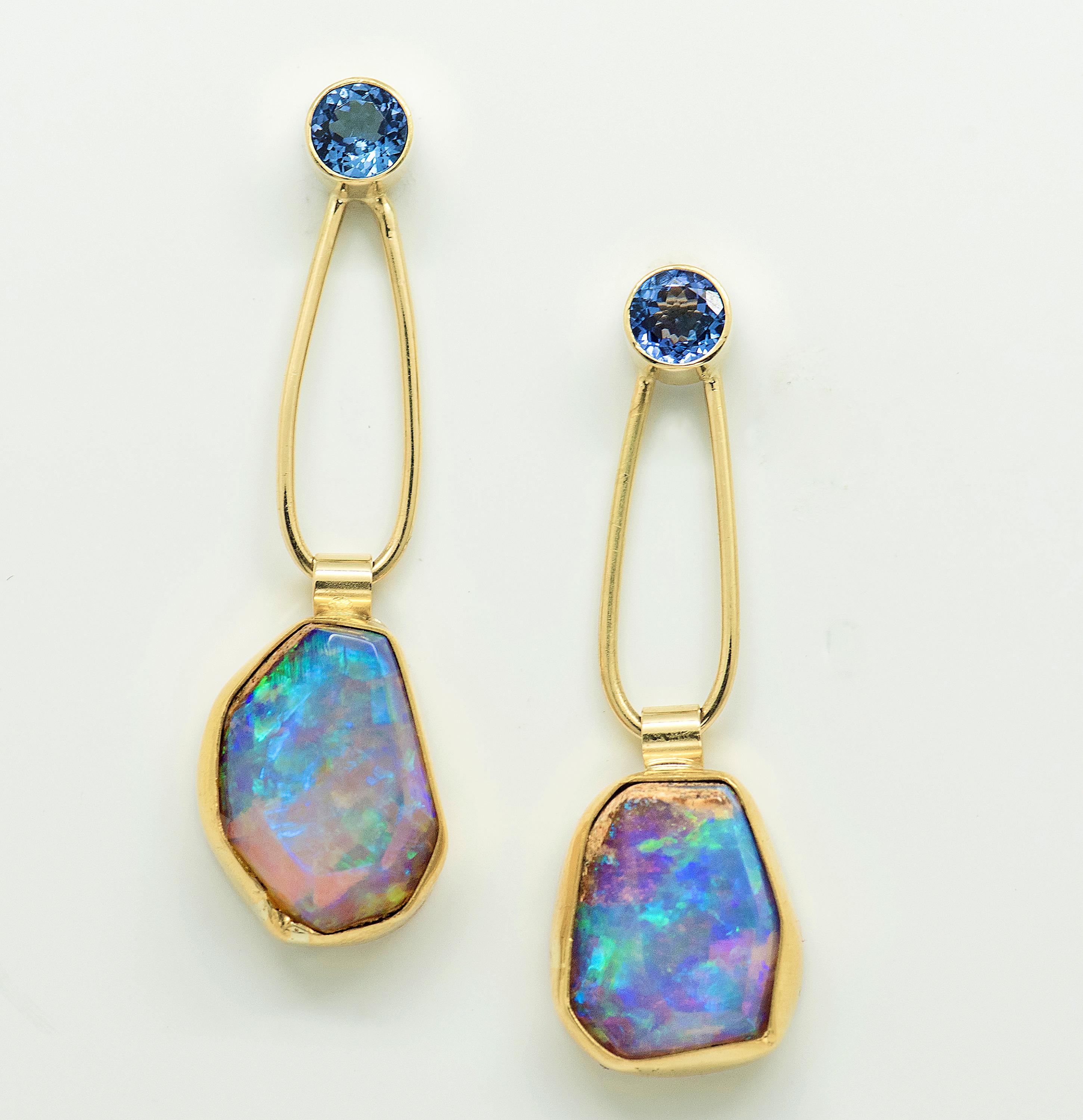 This Gem Opal earring found in petrified wood is swinging from a 5mm tanzanite; light, airy, and beautiful.  The high carat gold, 22k and 18k, frames and holds the color like a perfect frame should.  Sexy, long  and wearable.  