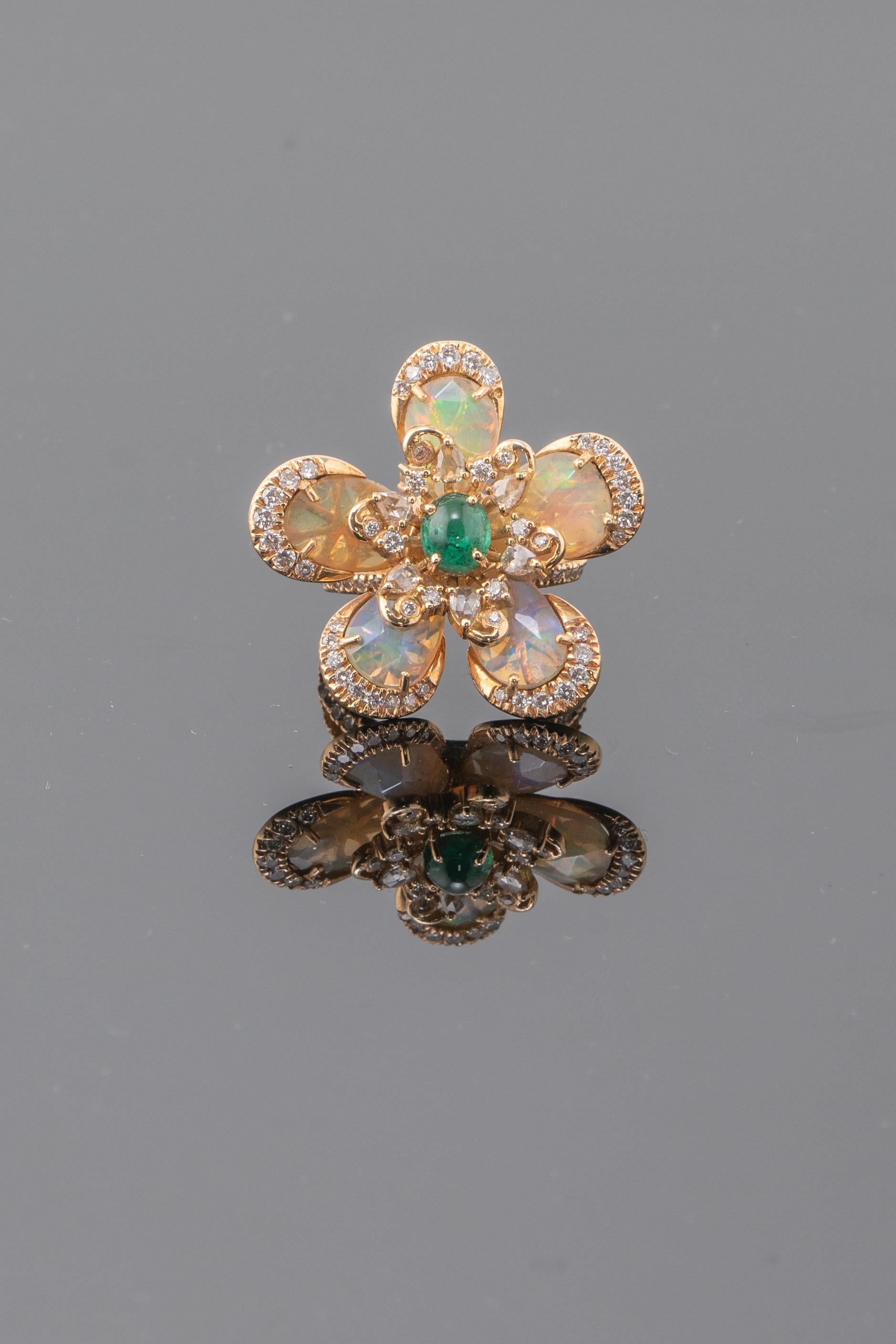 A statement, intricately hand-made cocktail ring. Using 4 carat fancy rose-cut, Ethiopian Opal floral ring with Zambian Emerald and Diamonds set in solid 18K yellow gold. 

Stone Details: 
Stone: Opal
Carat Weight: 4 Carats

Diamond Details: 
Total