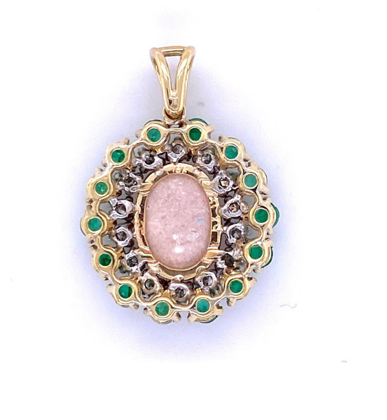 18 karat yellow gold pendant featuring a 14.5 mm by 10 mm opal. There are 14 3 mm round emerald stones on the outer edge of the pendant, with 0.90 carat of round brilliant diamonds between the line of emeralds and the opal. The gemstone design