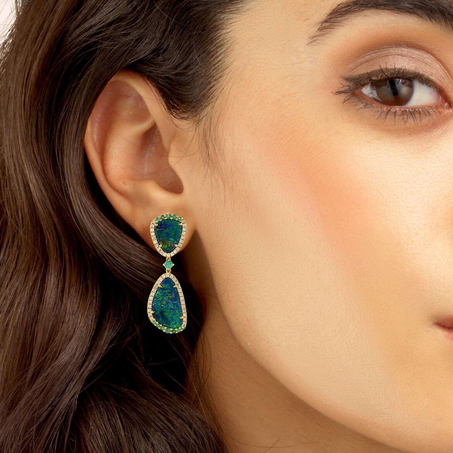 Handcrafted from 18-karat gold, these drop earrings are set with 7.33 carats Opal doublets, .80 carats emerald and .62 carats of glimmering diamonds. 

FOLLOW MEGHNA JEWELS storefront to view the latest collection & exclusive pieces. Meghna Jewels