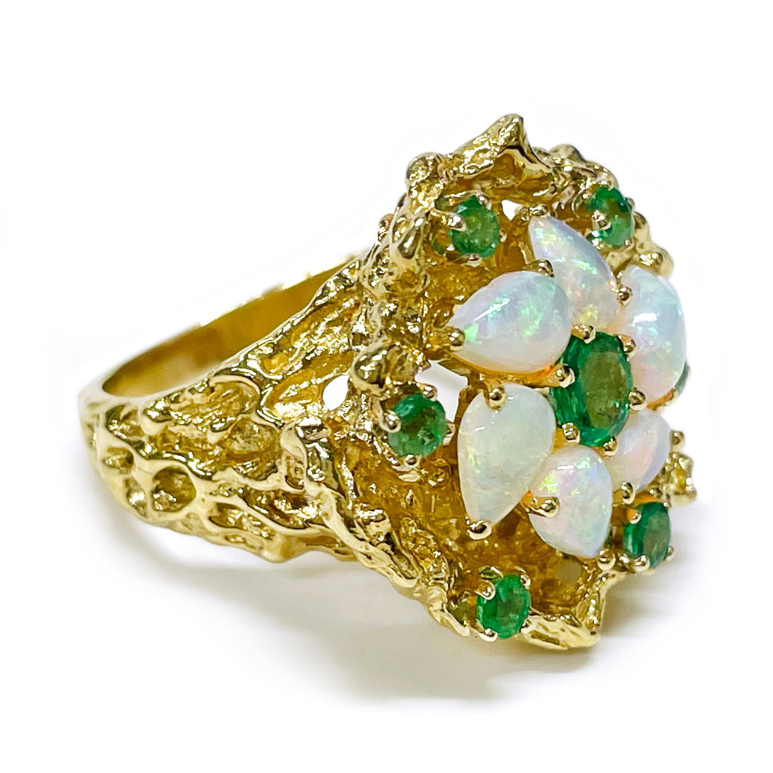 Electronically tested 18 Karat Yellow Gold Opal Emerald Nugget Ring. The ring features a cluster of six pear-shaped opals with a round emerald at the center and six round emeralds scattered around the design. The nugget texture is present on the top