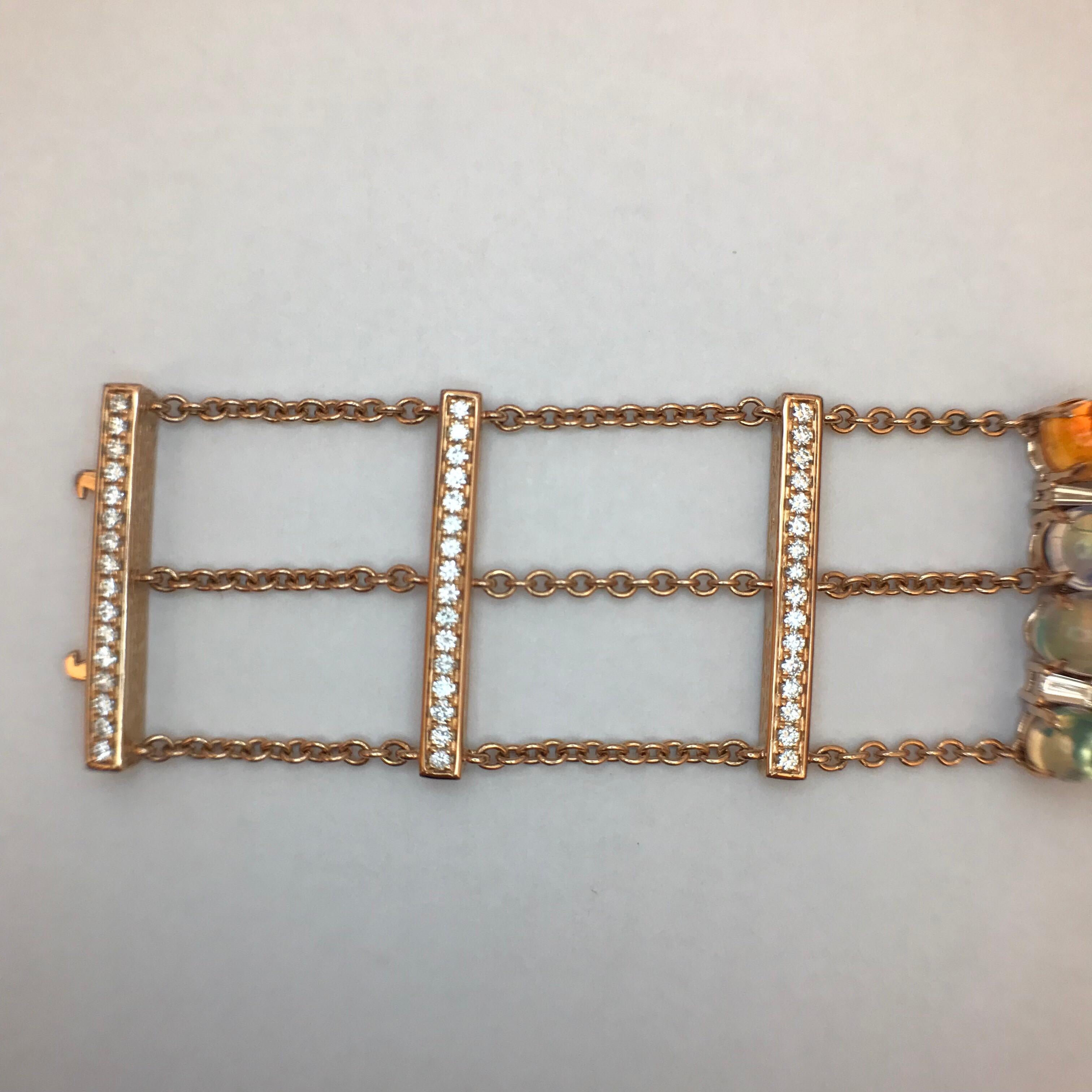 They say that “good things come in threes”, and this bracelet is no exception. Two sections composed of three chains and three bars accents a third section composed of crystalline opals, fire opals and diamonds. This quartet of trios come together