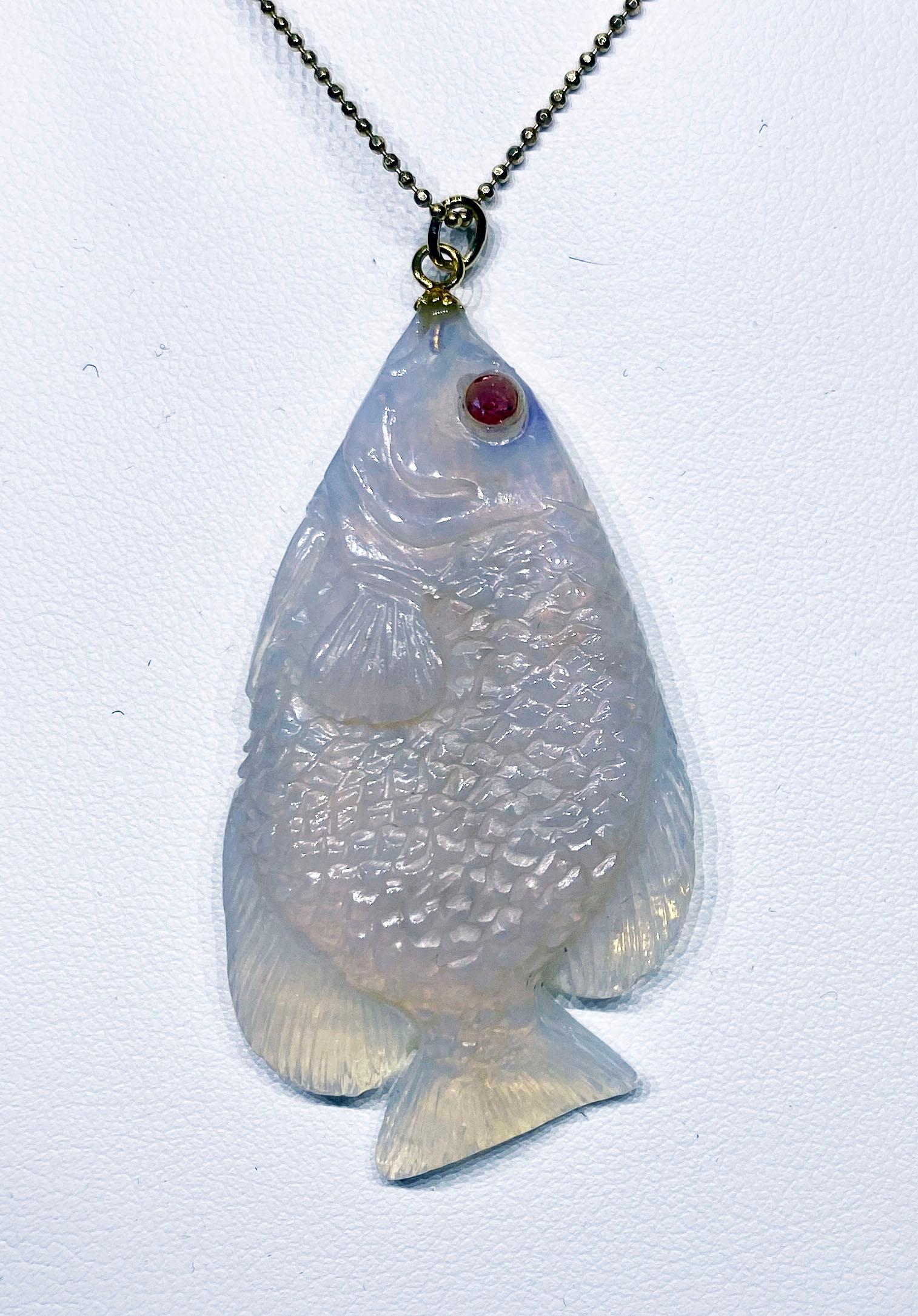 A 44 Carat Carved Opal Fish Pendant with Red Sapphire Eyes. This pendant is hanging from a Gold Plated Silver chain of 20 Inches. The Opal Pendant is 1 Inch Wide and 2.25 Inches Long.

Originally from San Diego, California, Kary Adam lived in the