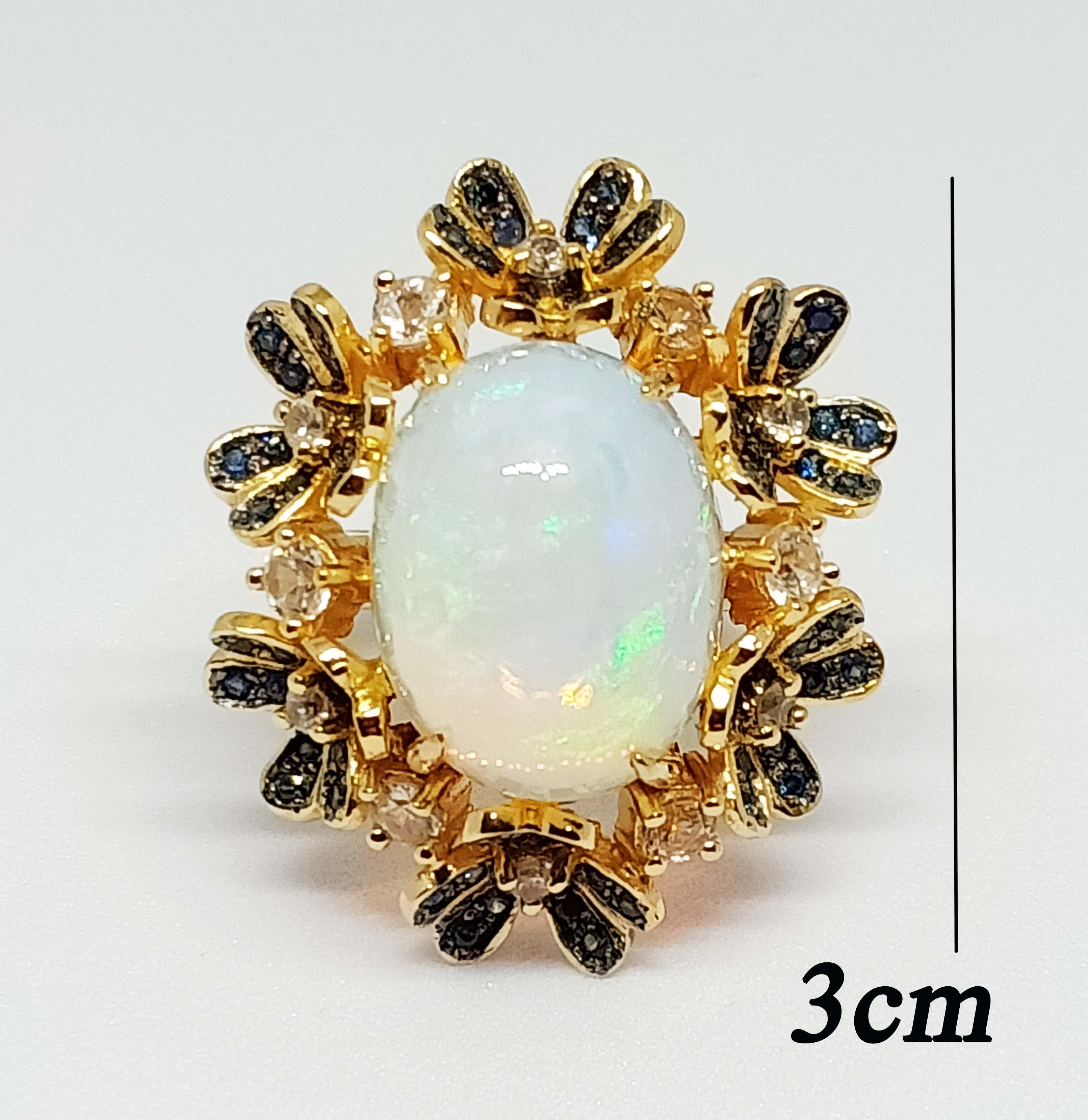 ( Big Ring )Opal flowers garden ring
Opal cabochon Oval size 17x13 mm. (10.80 cts.)
Blue sapphire 1.30 mm. 72 pcs. pave setting on black rhodium
White zircon 2.0 mm. 
White zircon 3.0 mm.
18 K Gold Plated Over Sterling Silver.

Search Sellers ,