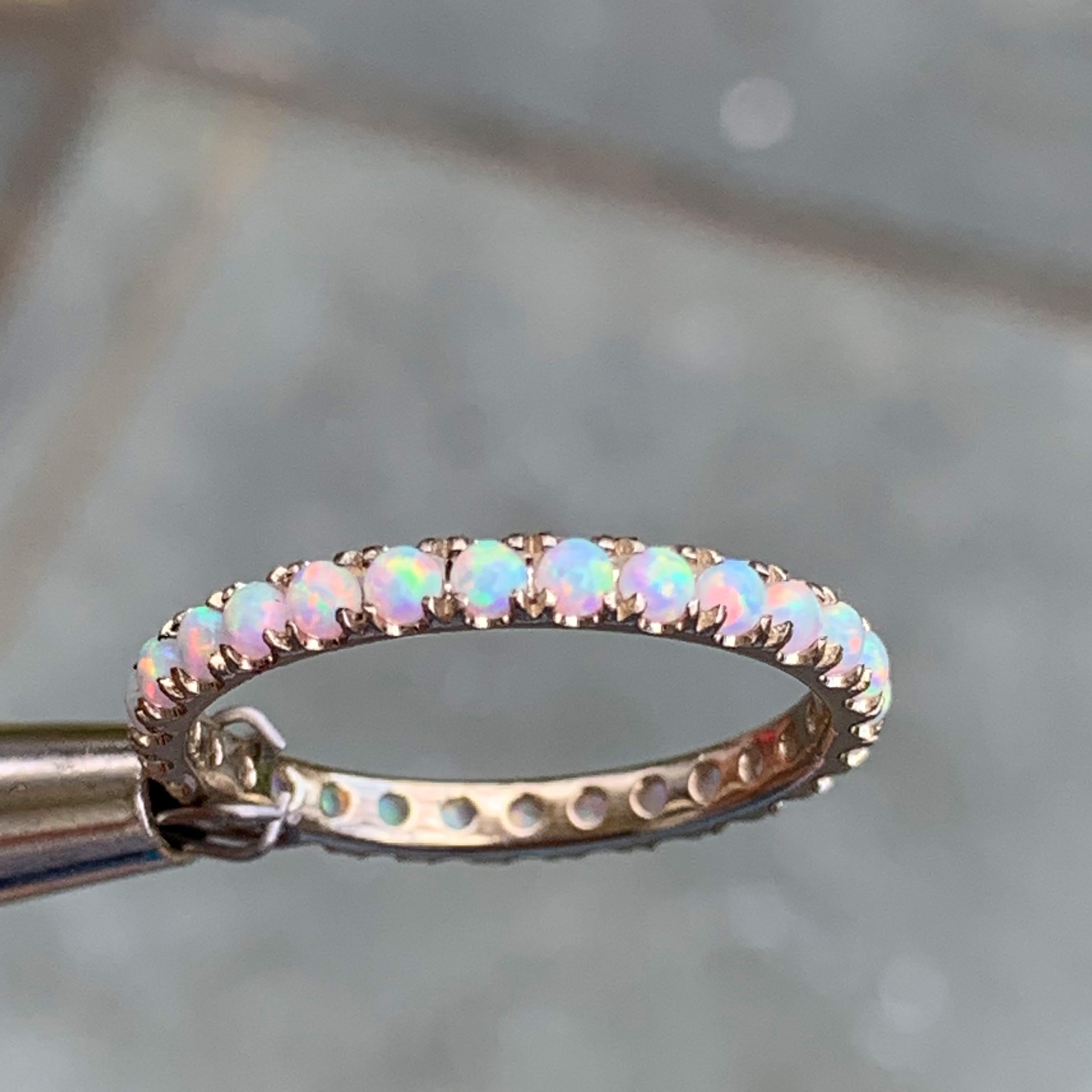 Made to order, please allow 2-5 weeks from date of final design approval by customer. 
Can be made in other sizes and also in other metals or stone colors.
 
A dainty row of brilliant round white lab created opal are set in this Full eternity ring