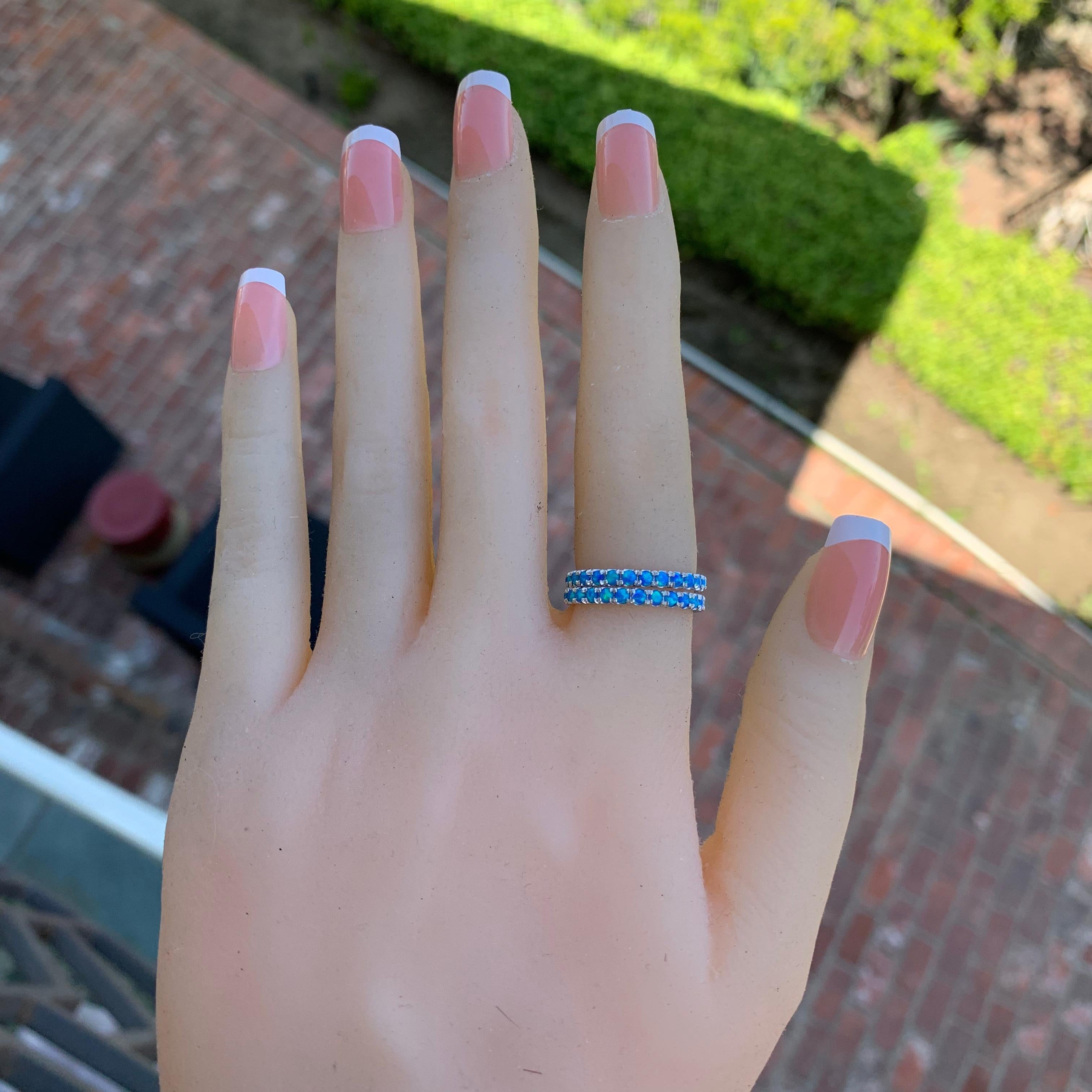 Made to order, please allow 2-5 weeks from date of final design approval by customer. 
Can be made in other sizes and also in other metals or stone colors.
 
A dainty row of brilliant round Blue lab created opal are set in this Full eternity ring