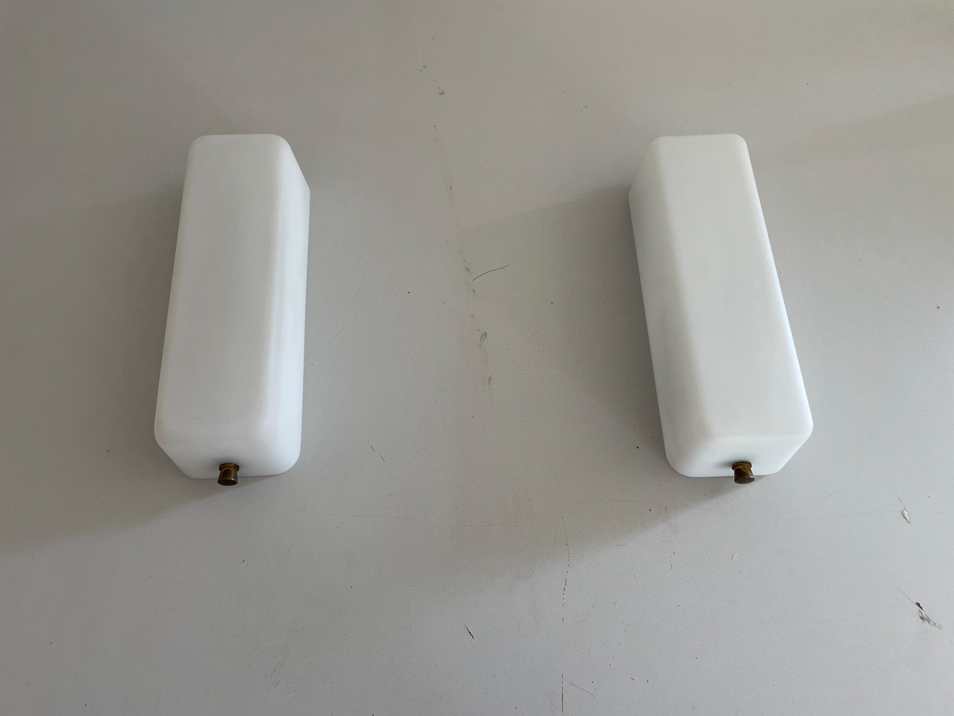 Opal Glass and Brass Base Pair of Wall Sconces by Stilux, 1960s, Italy

Elegant rare high quality wall lamps.
2 Pair available

Lamps are in very good vintage condition.
Wear consistent with age and use

These lamps works with 2x E14 standard light