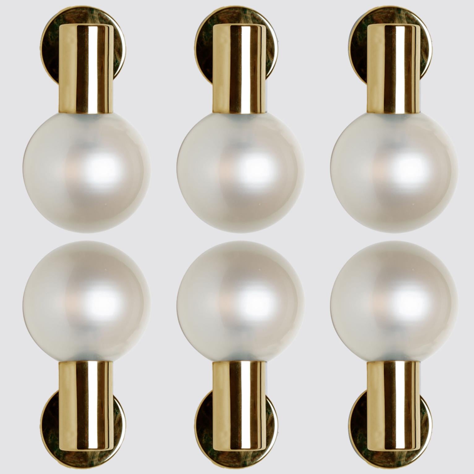 Large quantity of beautiful hand blown opal glass wall lights. Designed and manufactured by Glashütte Limburg, Germany around 1970.

Beautiful craftsmanship. These midcentury vintage lights feature a brass base with a fine opal glass shade.