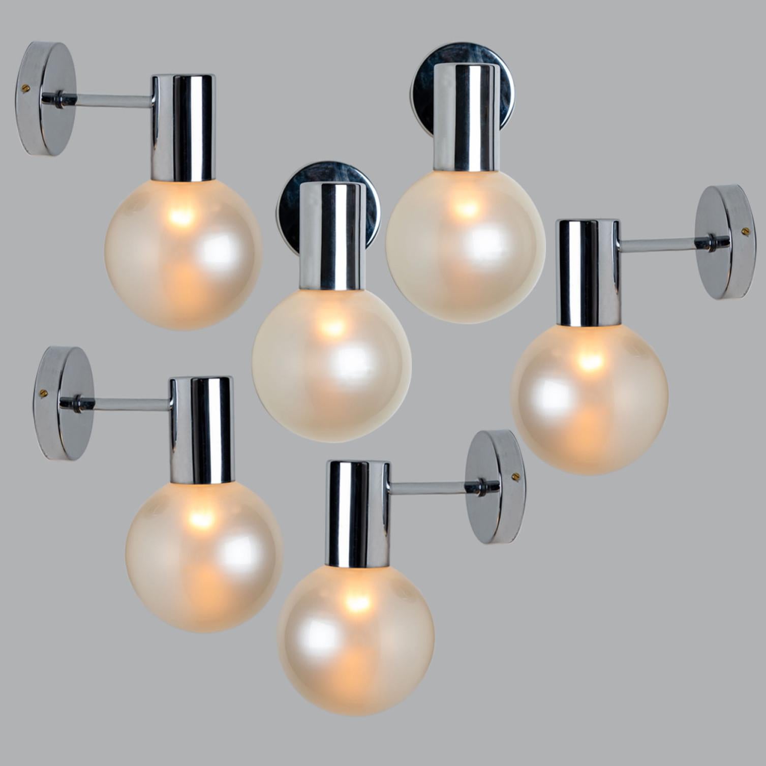 Large quantity of beautiful hand blown opal glass wall lights. Designed and manufactured by Glashütte Limburg, Germany around 1970.

Beautiful craftsmanship. These midcentury vintage lights feature a chrome base with a fine opal glass shade.
