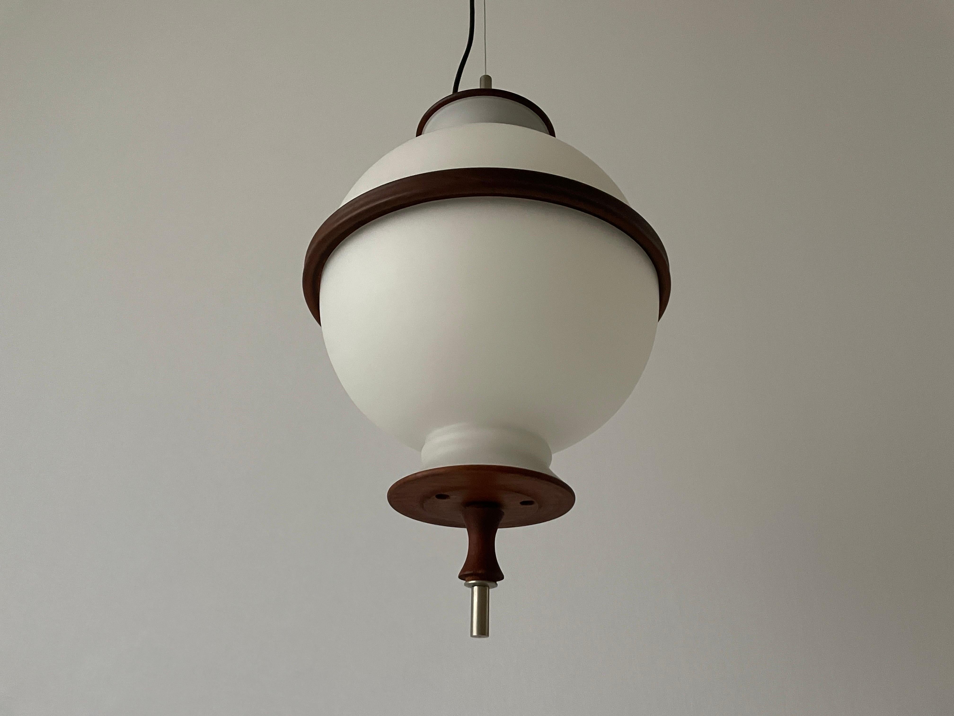 Opal Glass and Teak Ceiling Lamp by Reggiani Illuminazione, 1960s, Ital

This lamp works with E27 light bulbs. 
Wired and suitable to use with 220V and 110V for all countries.

Measurements:
Height: 140 cm (can be shortened)
Shade diameter and