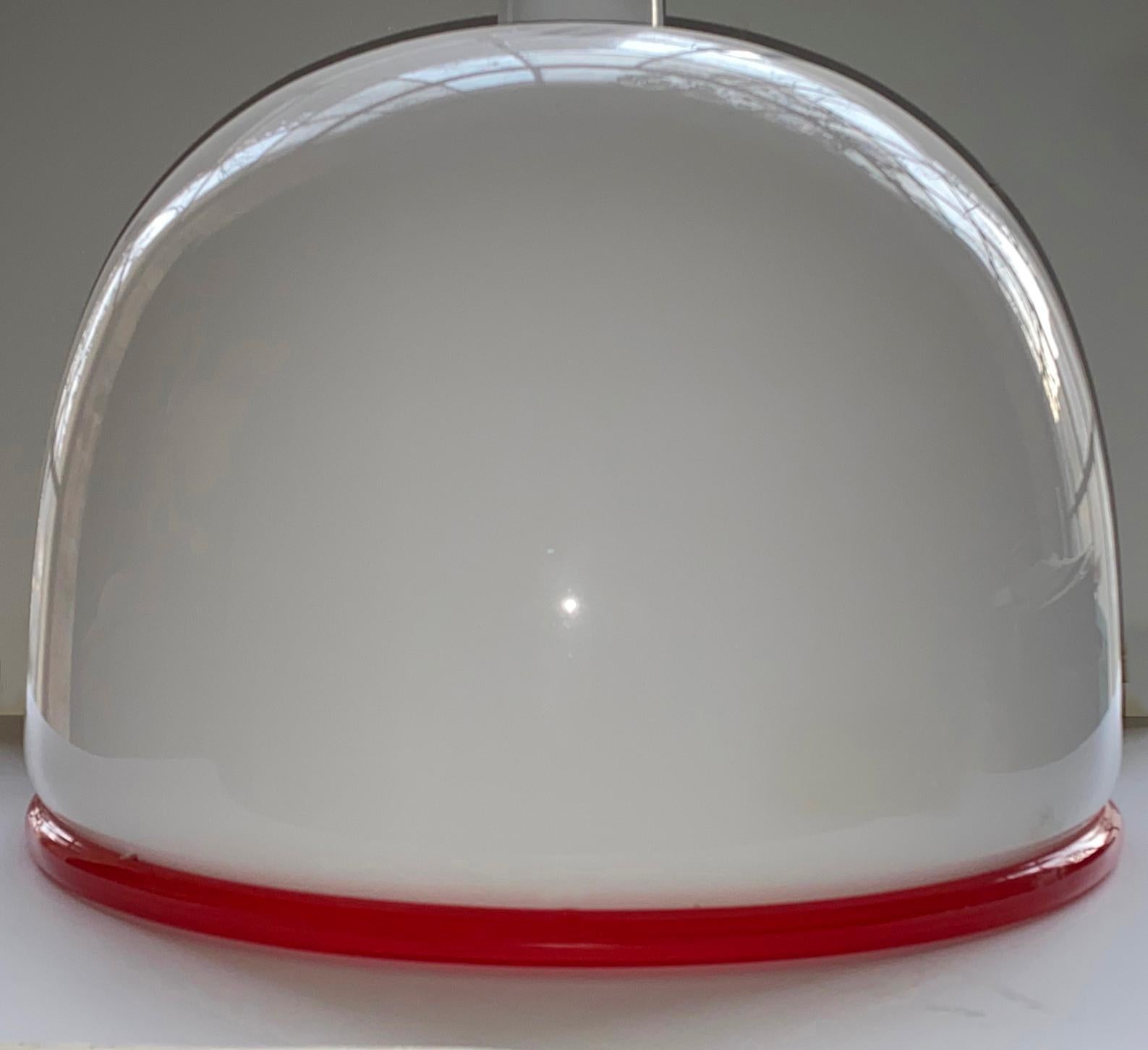 Murano Glass Pendant in bell shape.
Pendant lamp designed by Ettrre Sottsass in 1970s. Opal glass with applicated red glass edge ribbon. Glass perfect condition. The size of the opal glass dome is Height : 33 cm and Diameter 42 cm. The rest of