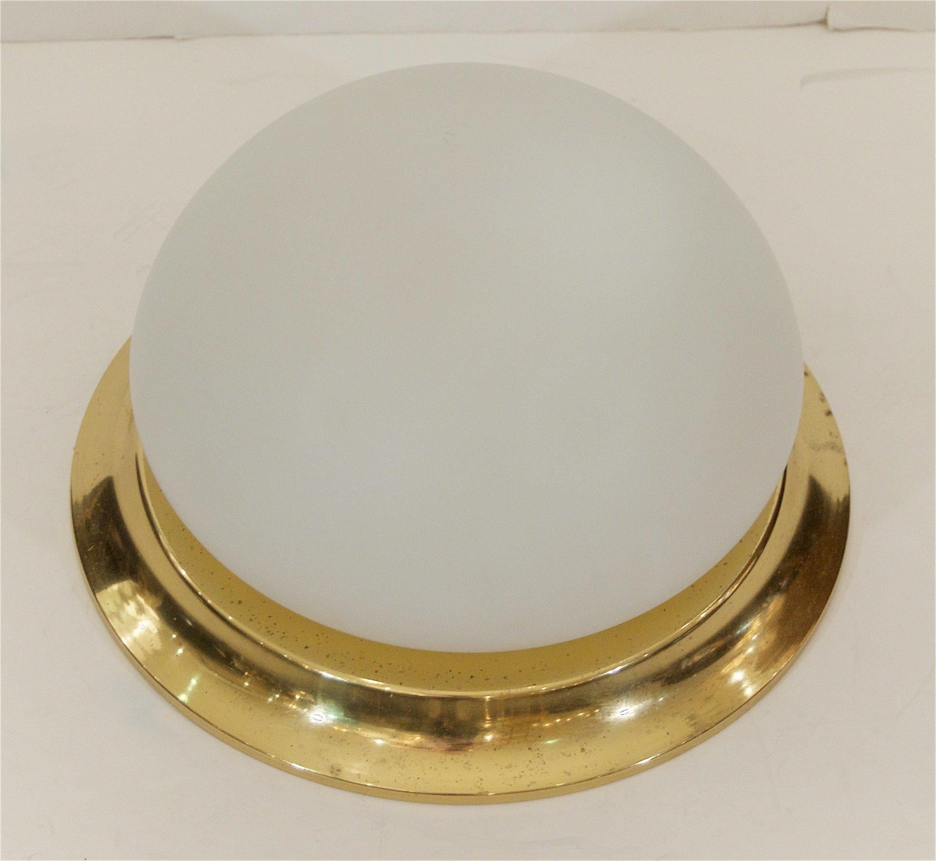 RZB Leuchten
Germany, 1960s

Well sized domed opal glass flush mount with a brass surround.

Takes one medium base bulbs up to 60 watts per bulb. New wiring.

Materials: Brass, opal glass
Excellent condition: Minor wear consistent with age and
