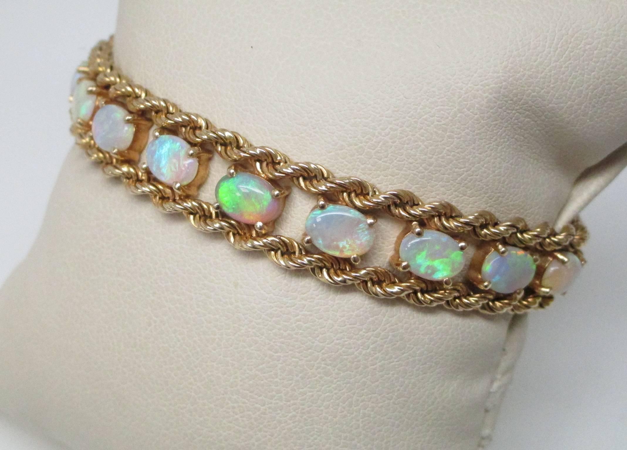 Photos never show just how beautiful opals are. This bracelet has 15+ carats of opal cabochons cradled by 14K yellow gold. The bracelet has a wonderful drape and is a joy to wear. There will be so many people who stop you to admire this stunning