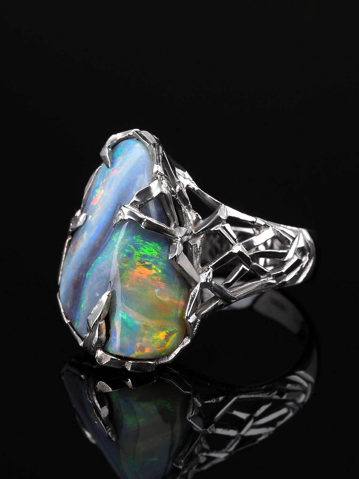 This ring has a majestic Boulder Opal in a sublime White Gold body that has a medieval structured design. Crafted with utmost precision, the Boulder Opal has a brilliantly polished surface along with its gorgeous play of color, lofty color bar, and