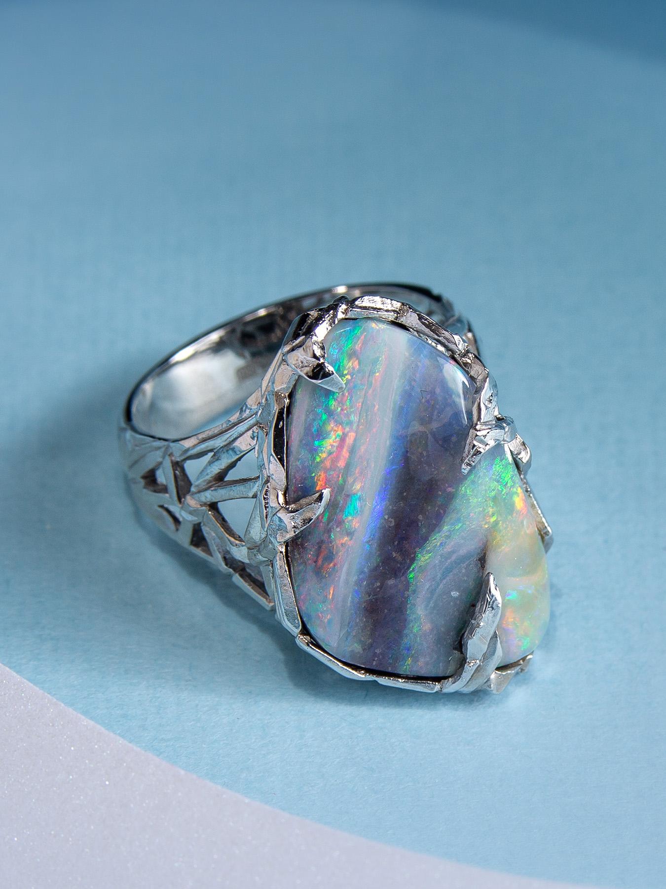 This ring has a majestic Boulder Opal in a sublime White Gold body that has a medieval structured design. Crafted with utmost precision, the Boulder Opal has a brilliantly polished surface along with its gorgeous play of color, lofty color bar, and
